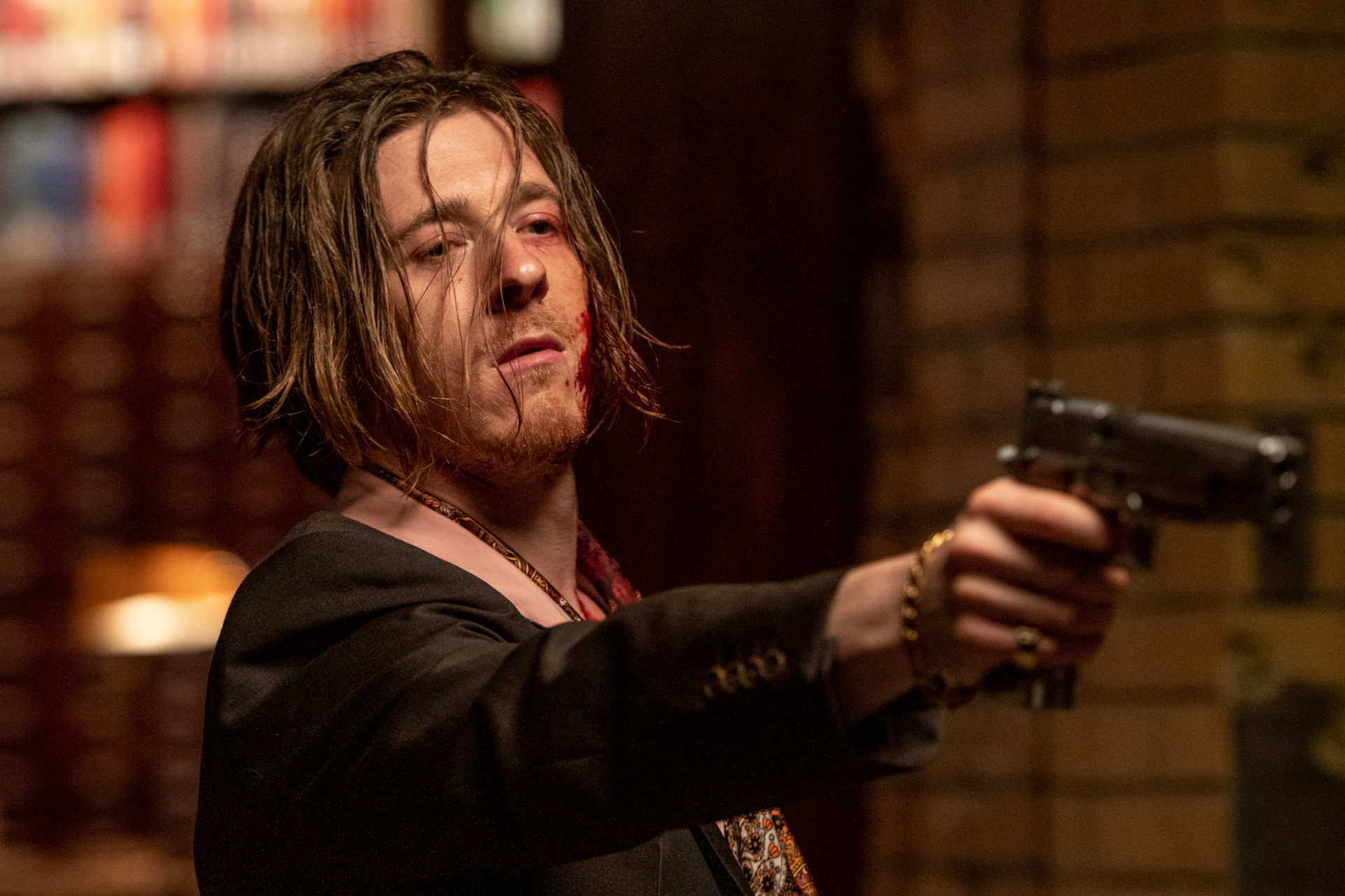 Adam Nagaitis with blood and a gun in Gunpowder Milkshake HD Wallpaper