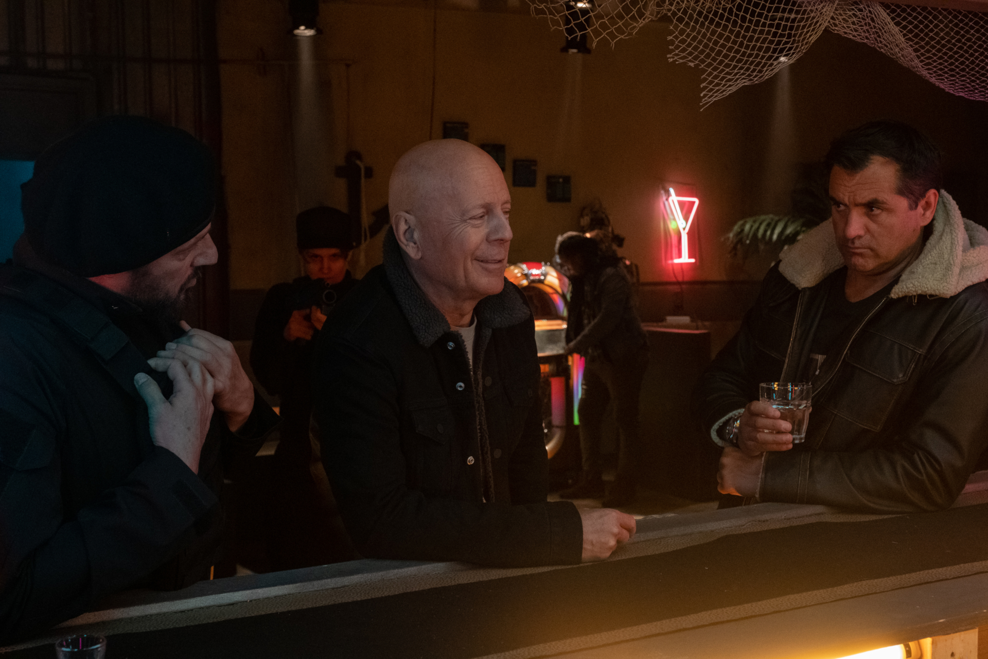Bruce Willis smiles at a bar in Cosmic Sin. HD Wallpaper