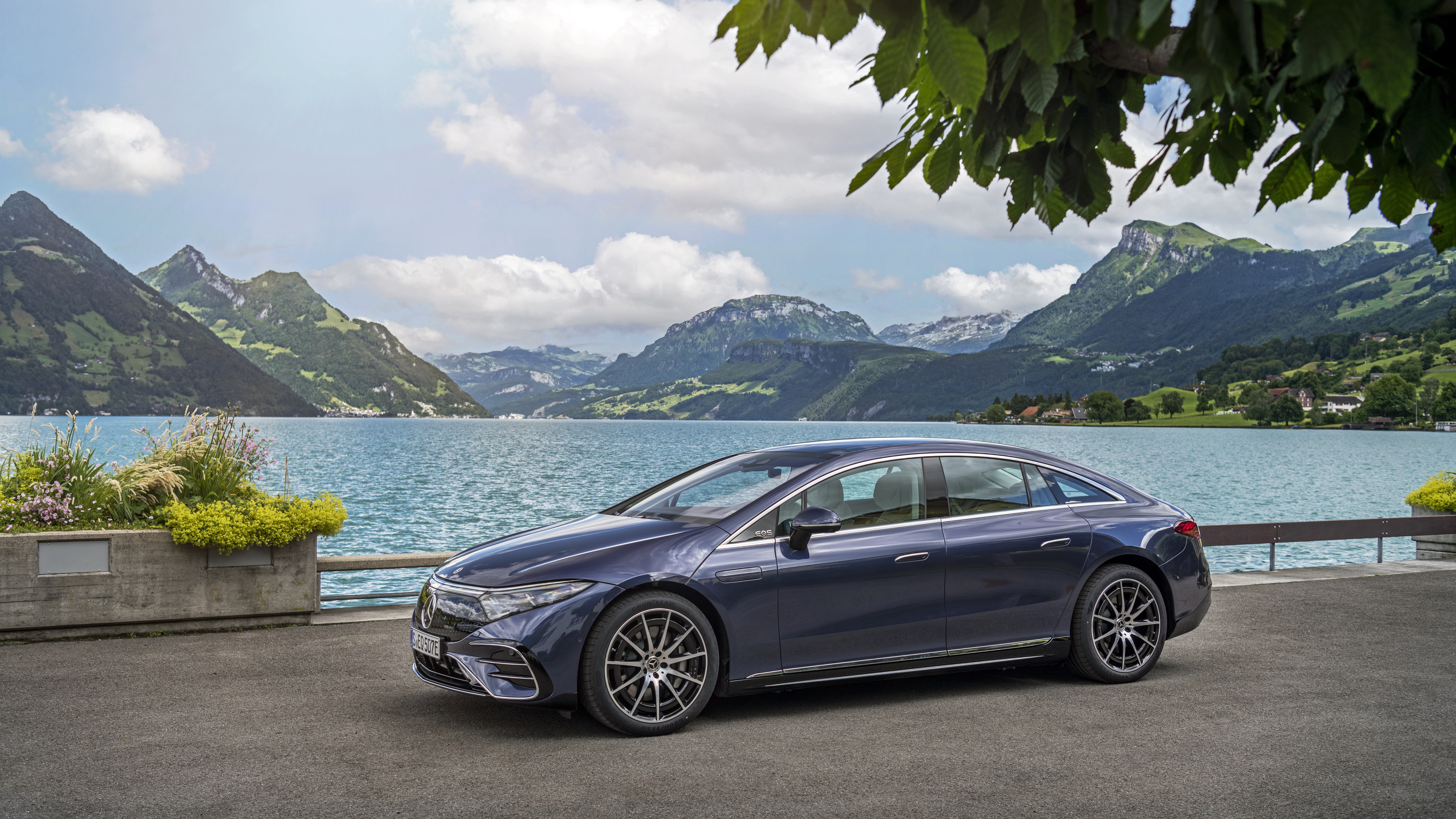 Blue Mercedes-Benz EQS 450+ AMG Line by a scenic lake HD Wallpaper