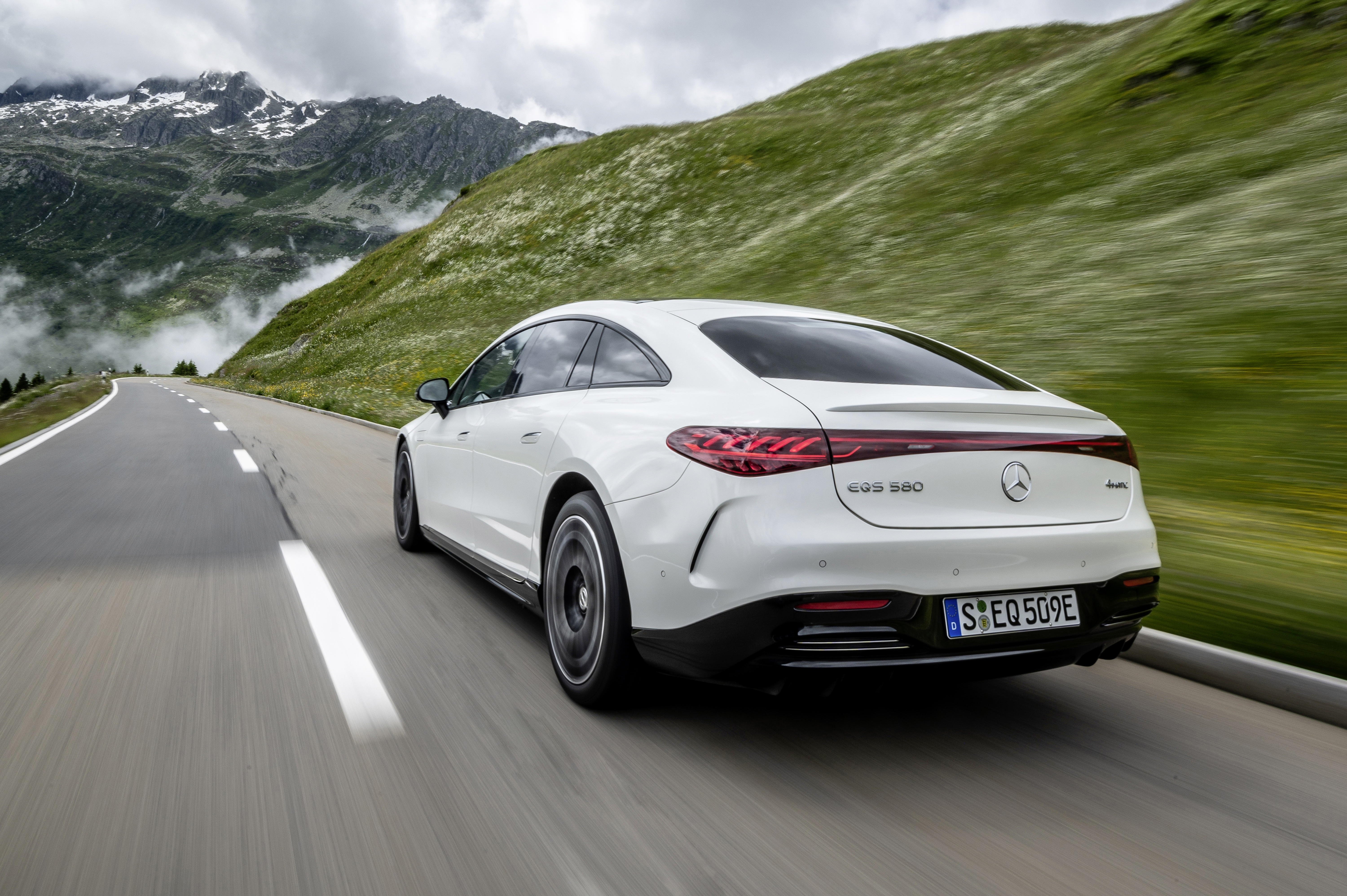 Luxury Electric Mercedes-Benz EQS 580 on a mountain road HD Wallpaper