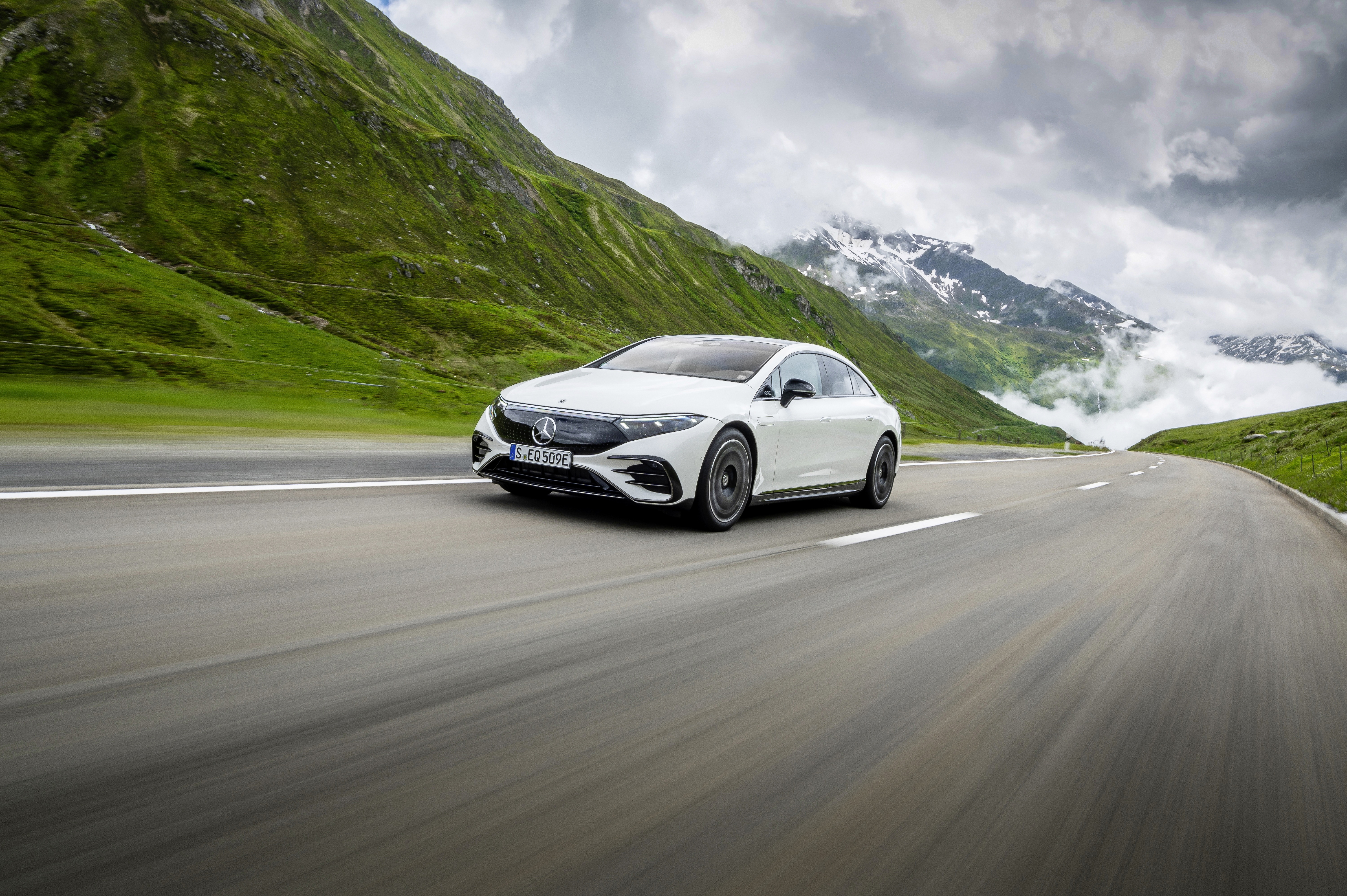Mercedes-Benz EQS electric luxury car driving in mountains HD Wallpaper