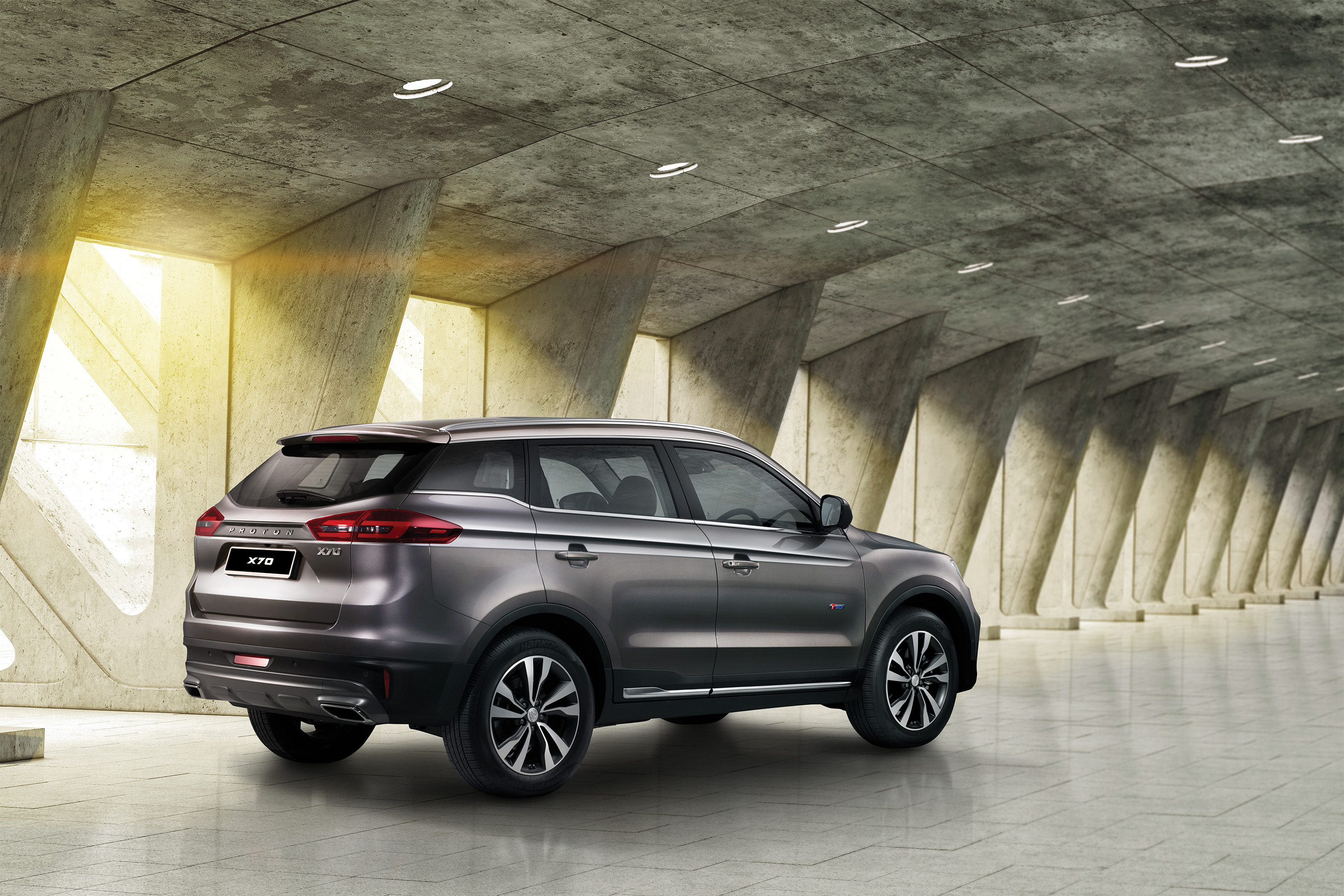 Proton X70 SUV in modern concrete architecture HD Wallpaper