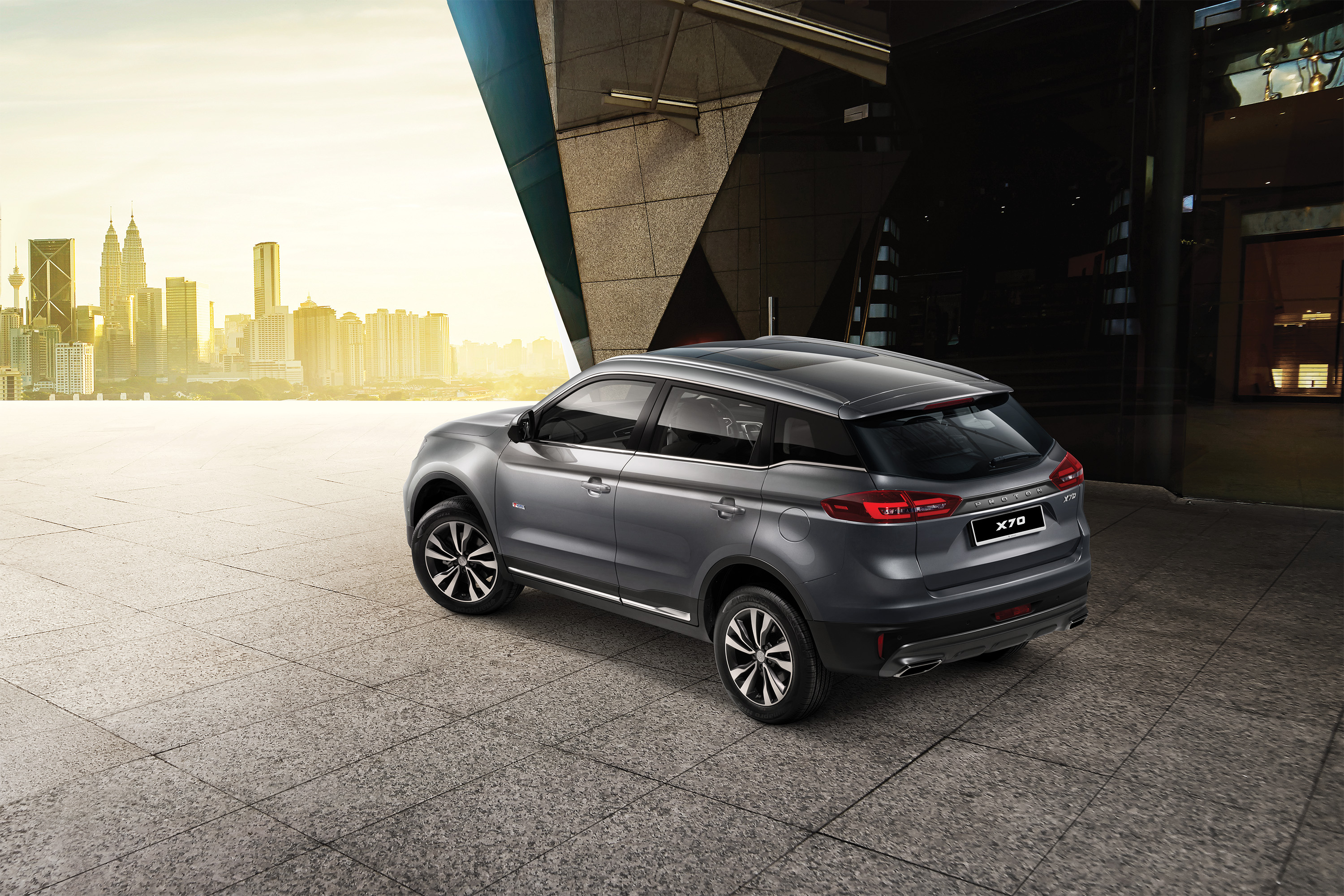 Proton X70 SUV with Kuala Lumpur city skyline HD Wallpaper