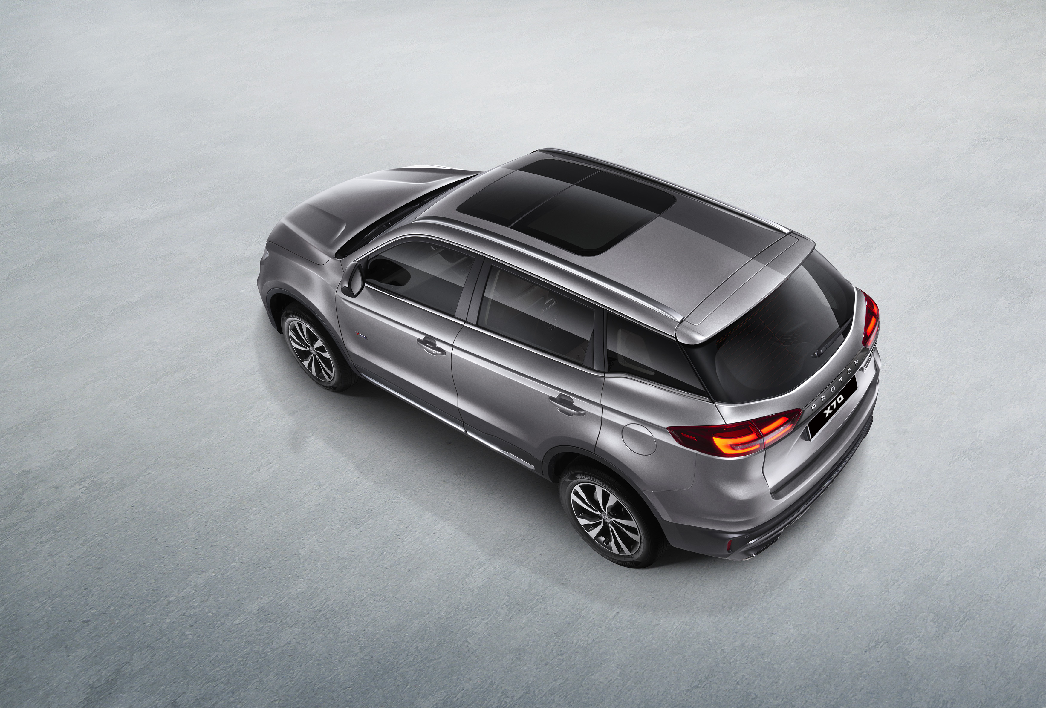 Overhead view of a silver Proton X70 SUV HD Wallpaper