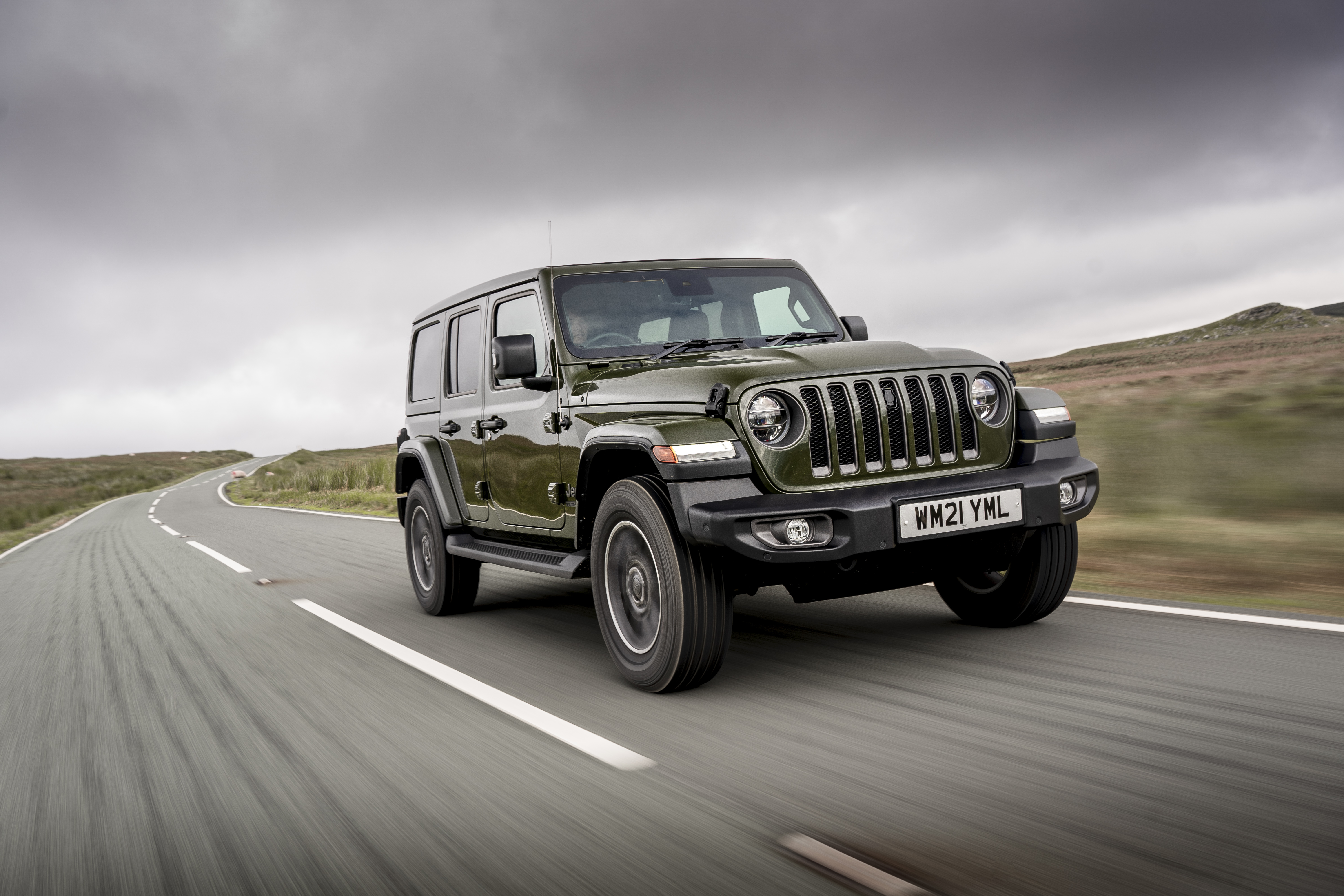 Green 2021 Jeep Wrangler "80th Anniversary" driving on road HD Wallpaper