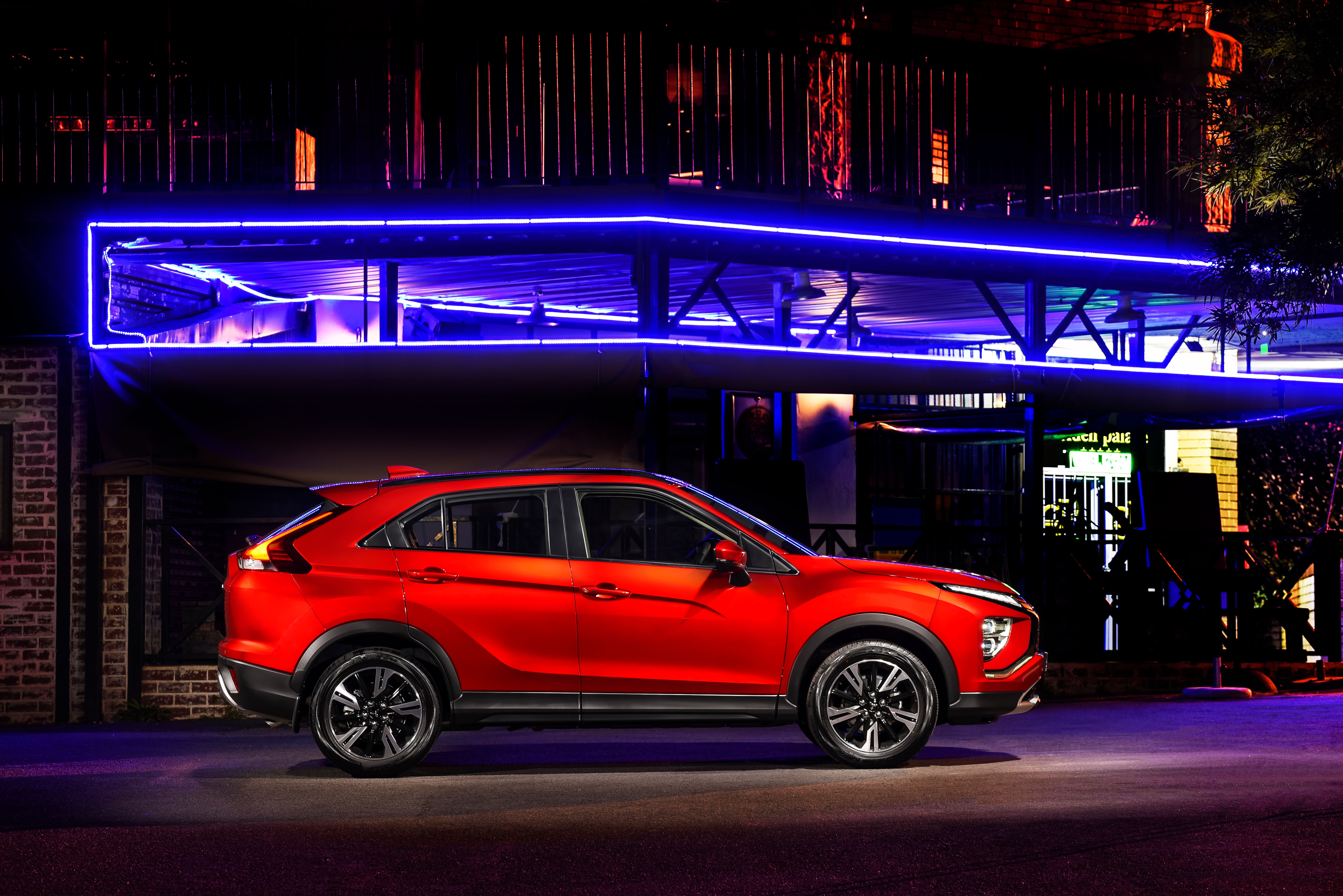 Red Mitsubishi Eclipse Cross SUV under blue neon lights HD Wallpaper