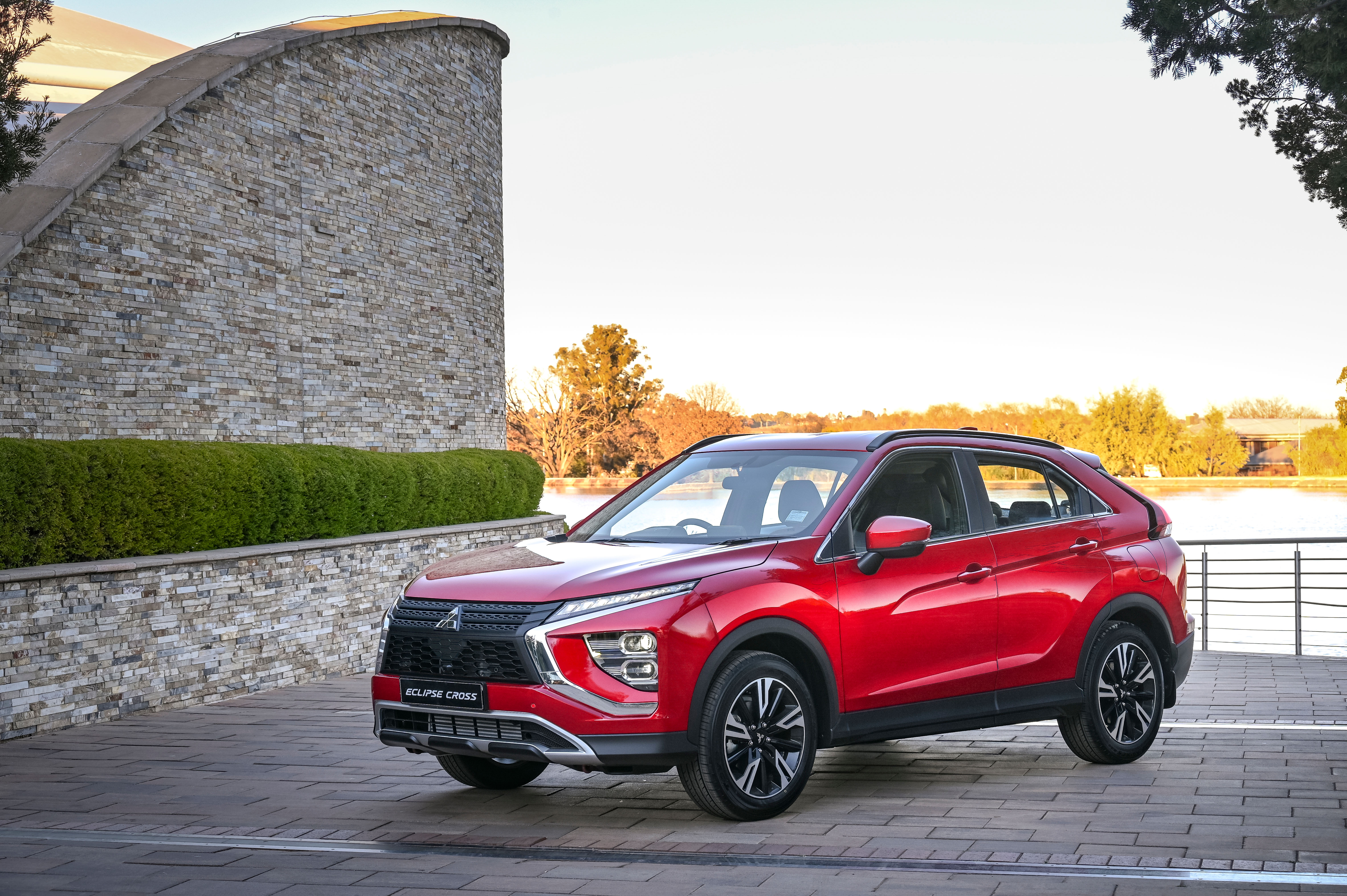 Red Mitsubishi Eclipse Cross SUV by the water HD Wallpaper