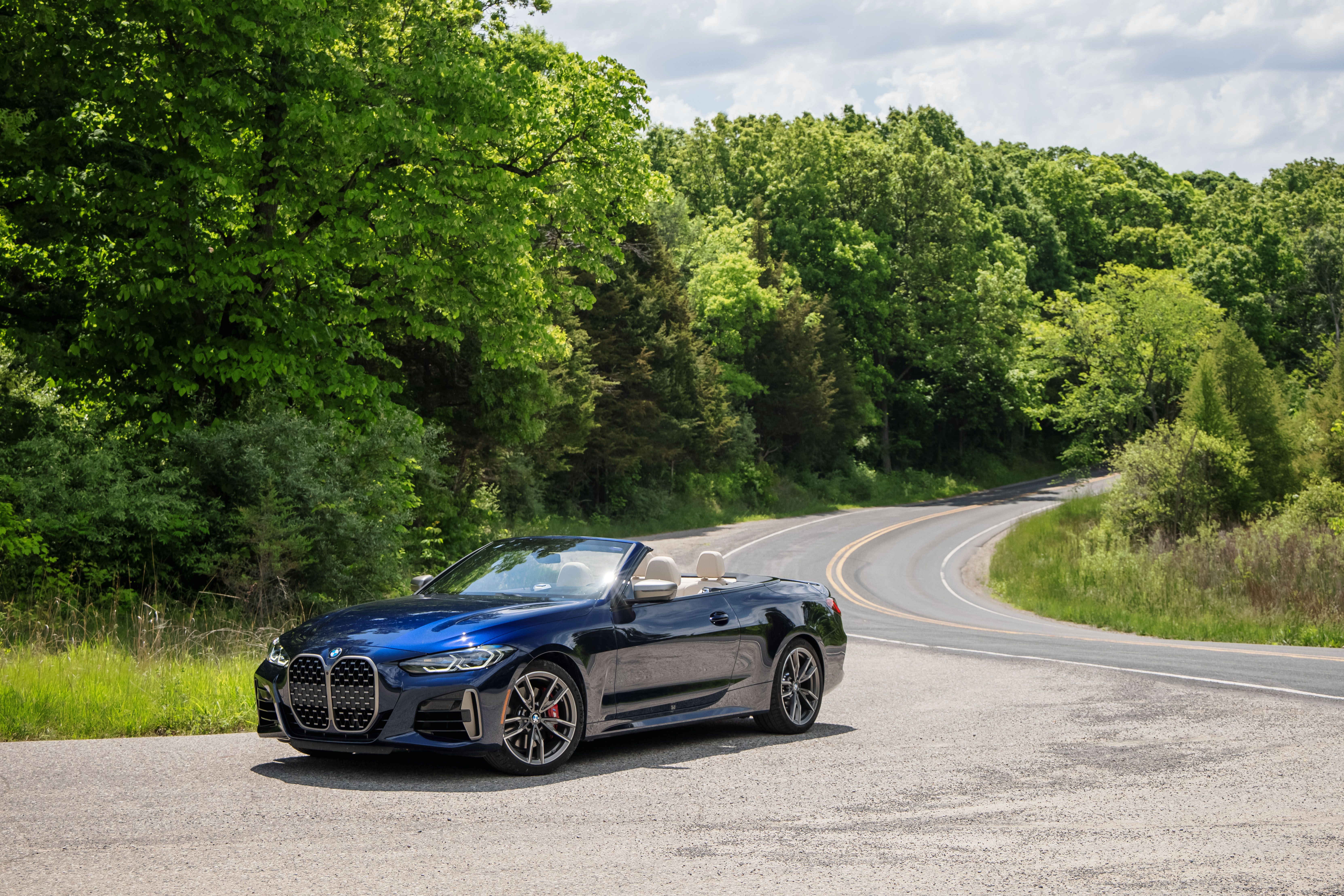 Blue BMW M440i Cabriolet on a winding road HD Wallpaper
