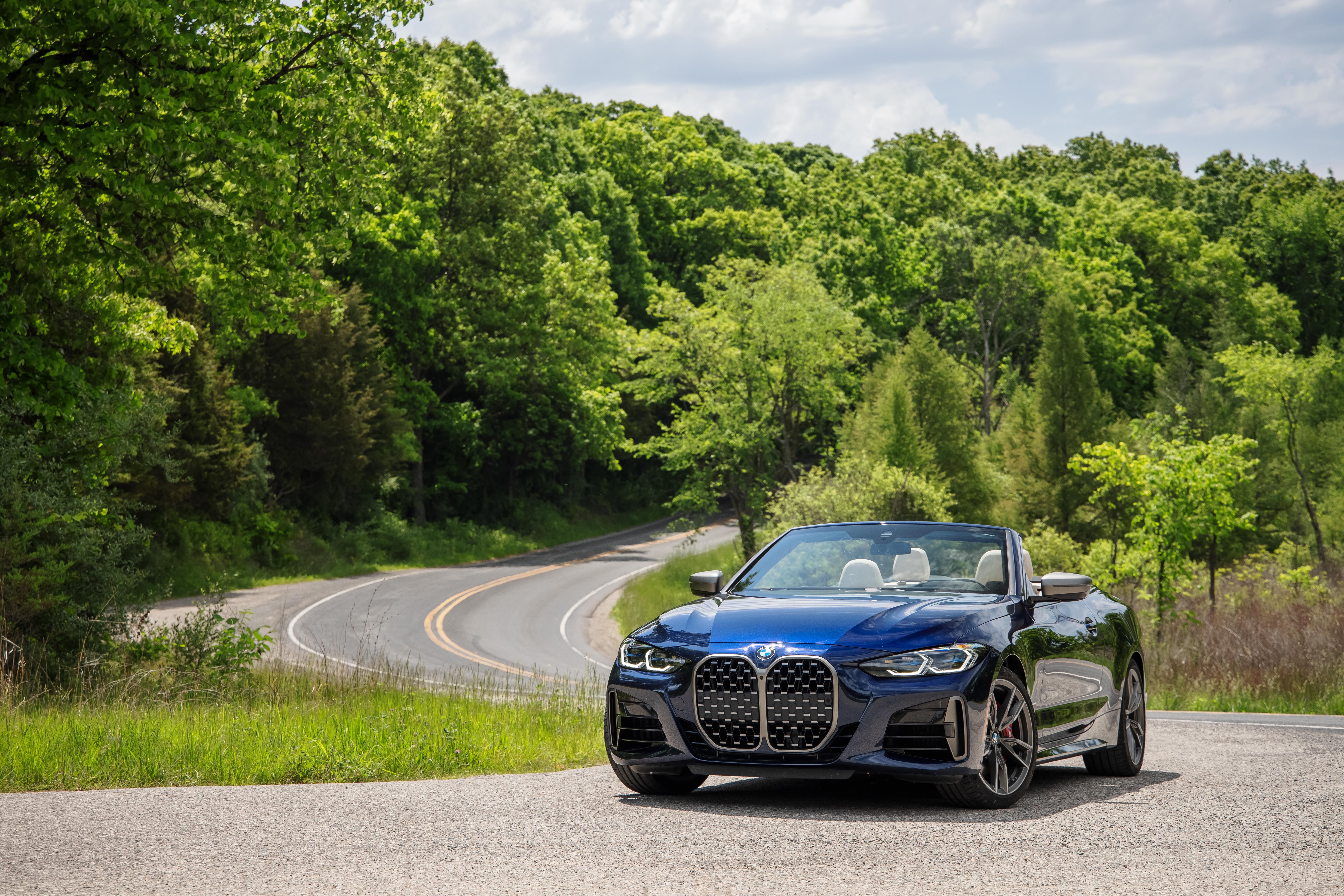 Blue BMW M440i Cabriolet on a scenic winding road HD Wallpaper