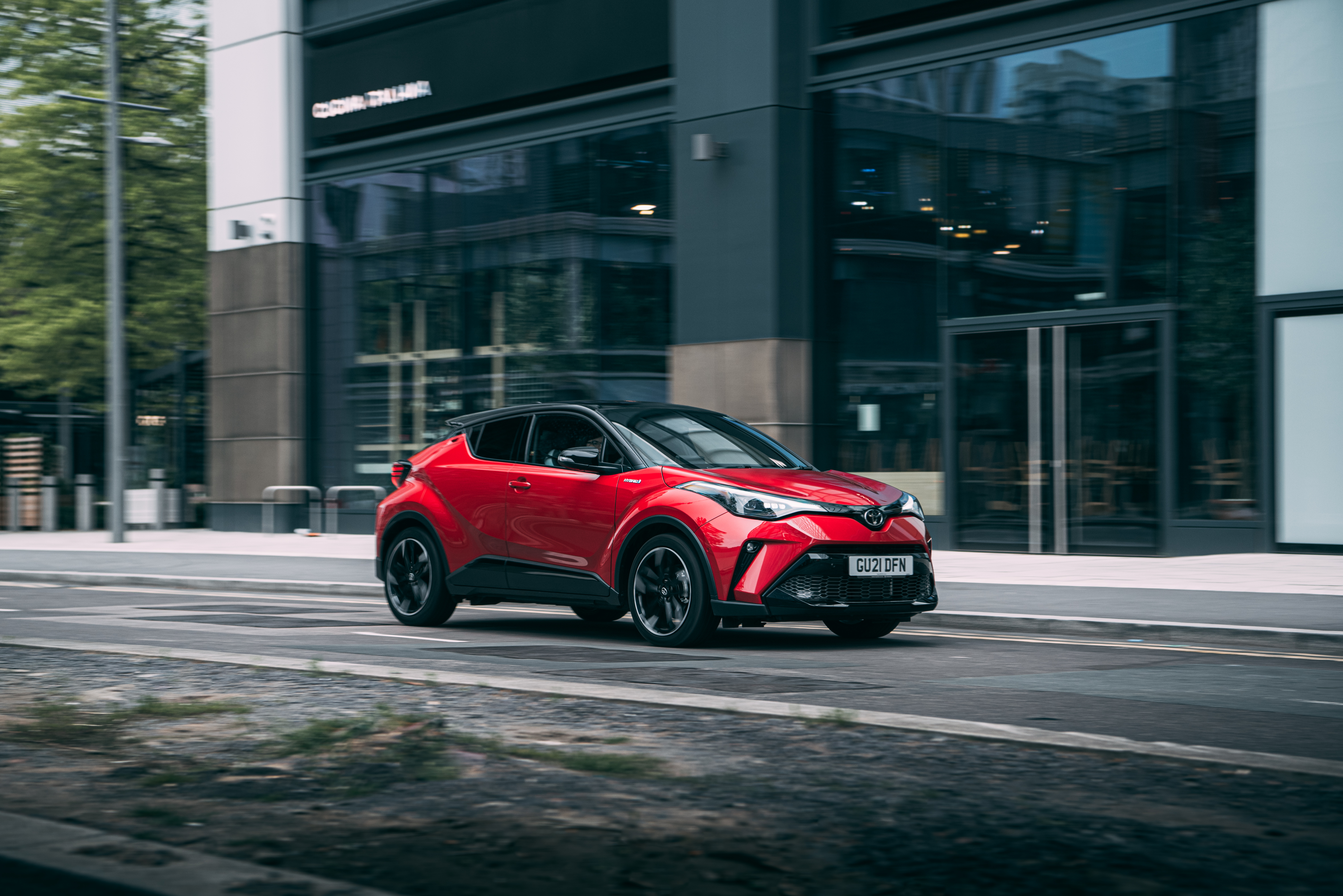 Red Toyota C-HR Hybrid GR Sport SUV driving on street HD Wallpaper