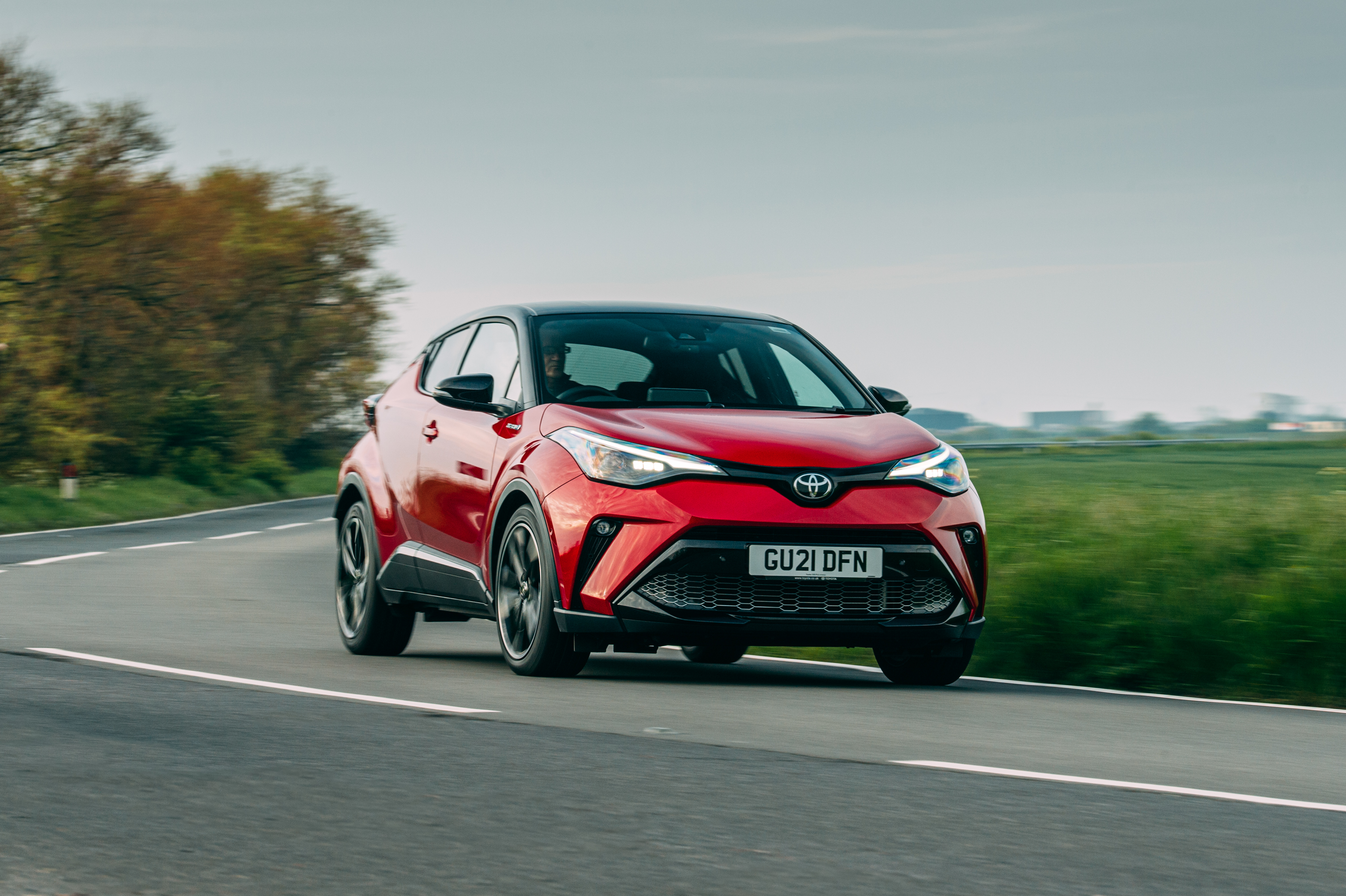 Red Toyota C-HR Hybrid GR Sport SUV on road HD Wallpaper