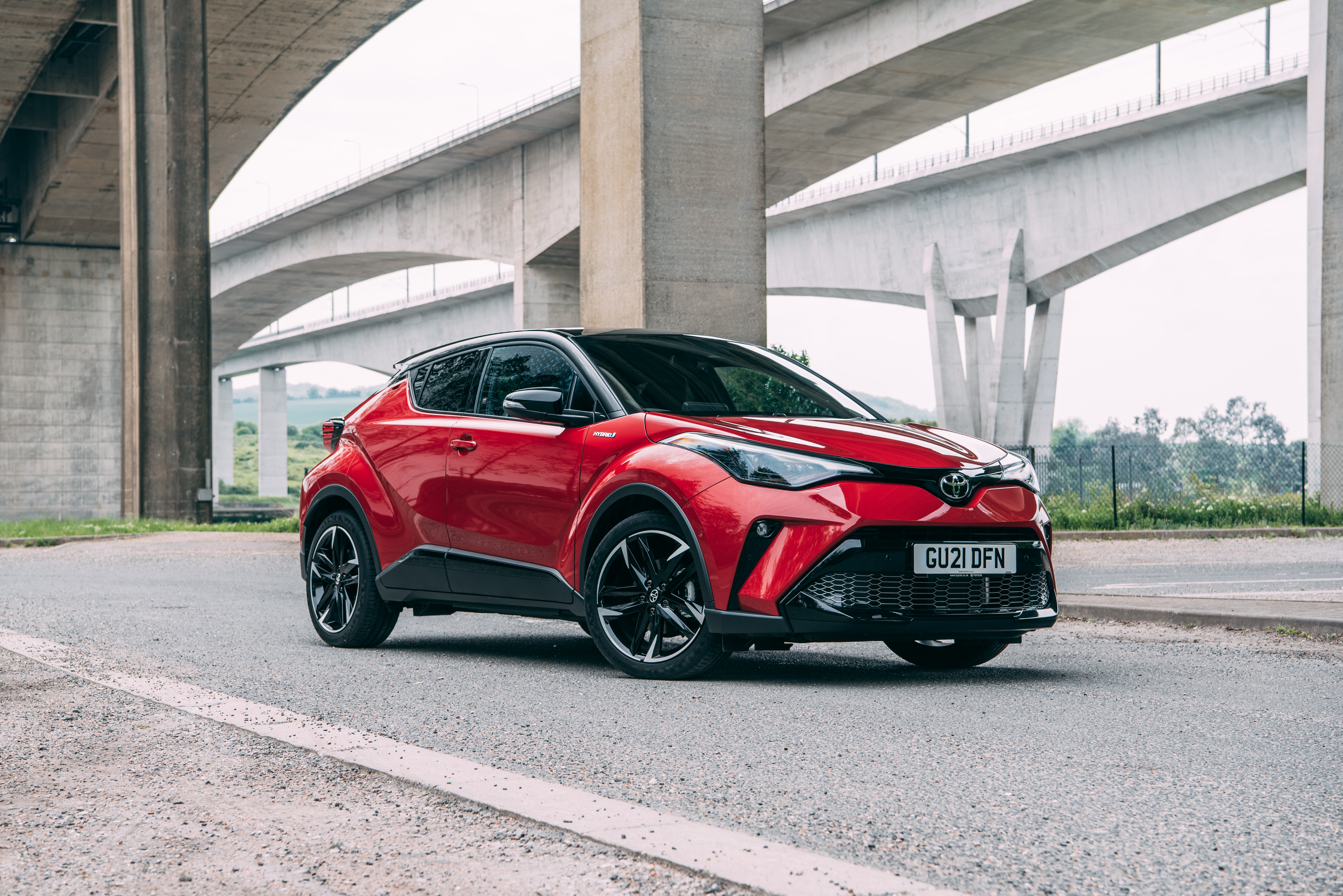 Red Toyota C-HR Hybrid GR Sport SUV under bridge HD Wallpaper