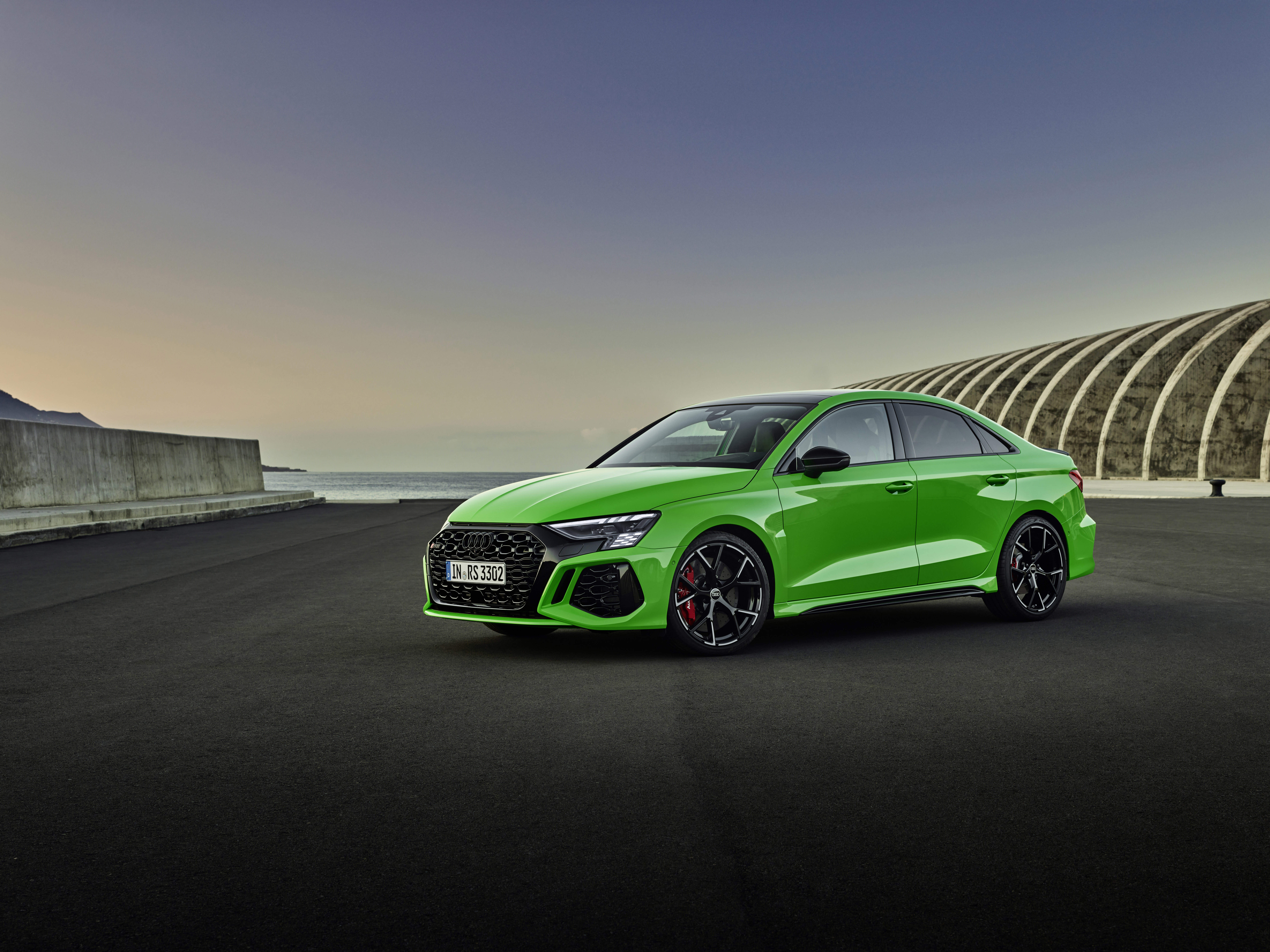 Audi RS3 Sedan in bright green by the sea HD Wallpaper