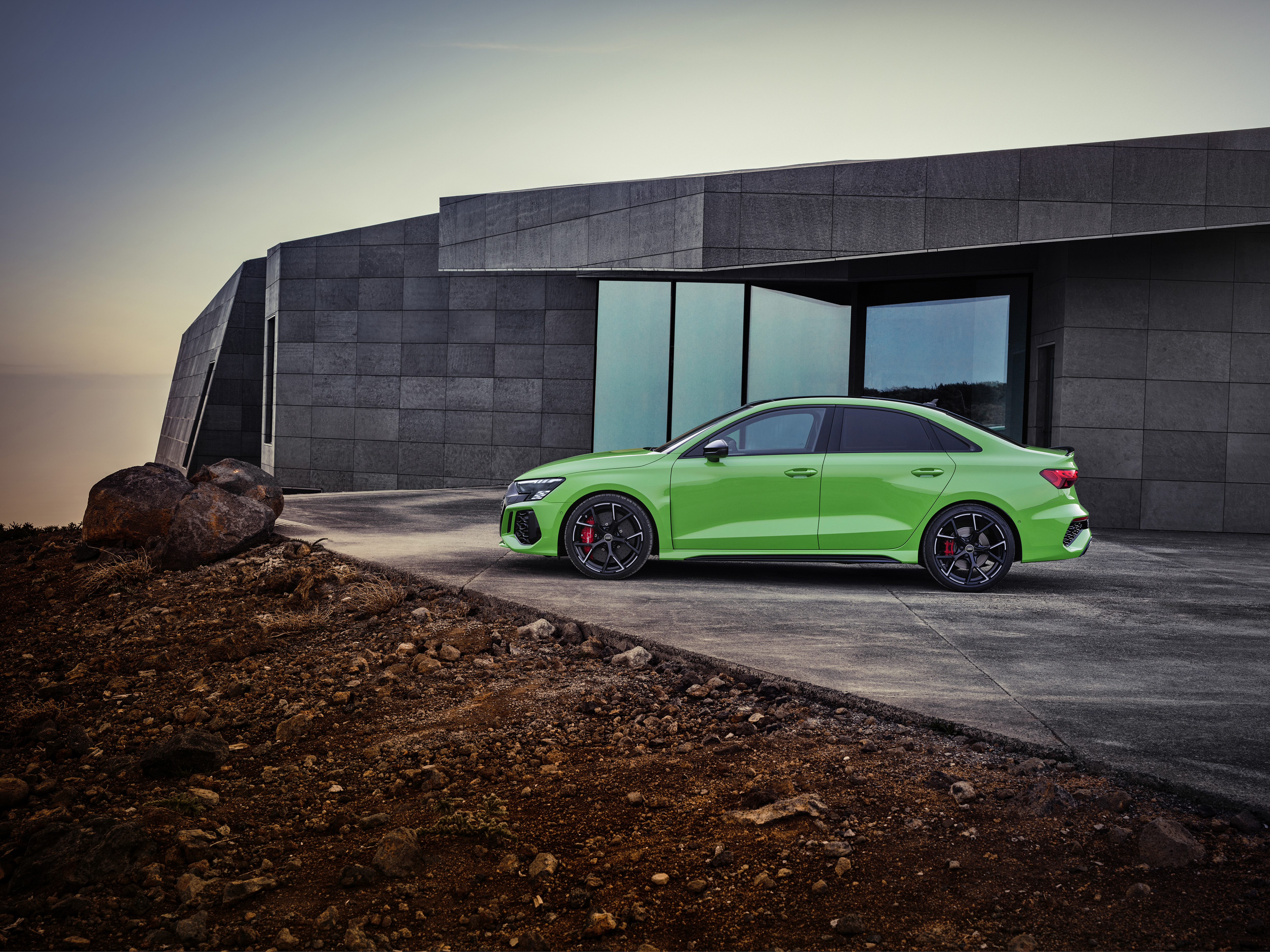 Green Audi RS3 Sedan by a modern house HD Wallpaper