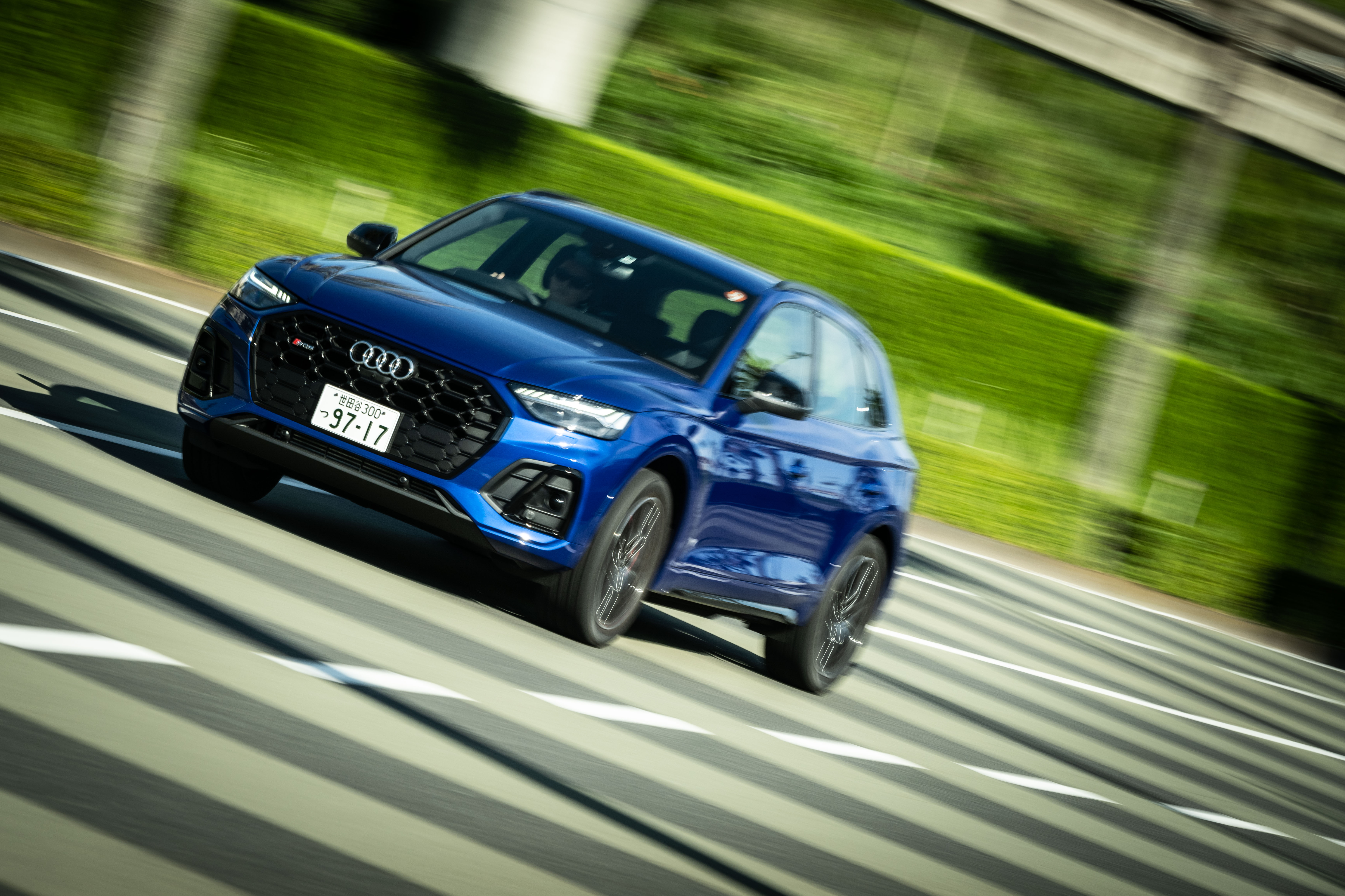 Blue Audi SQ5 SUV driving on road with motion blur HD Wallpaper