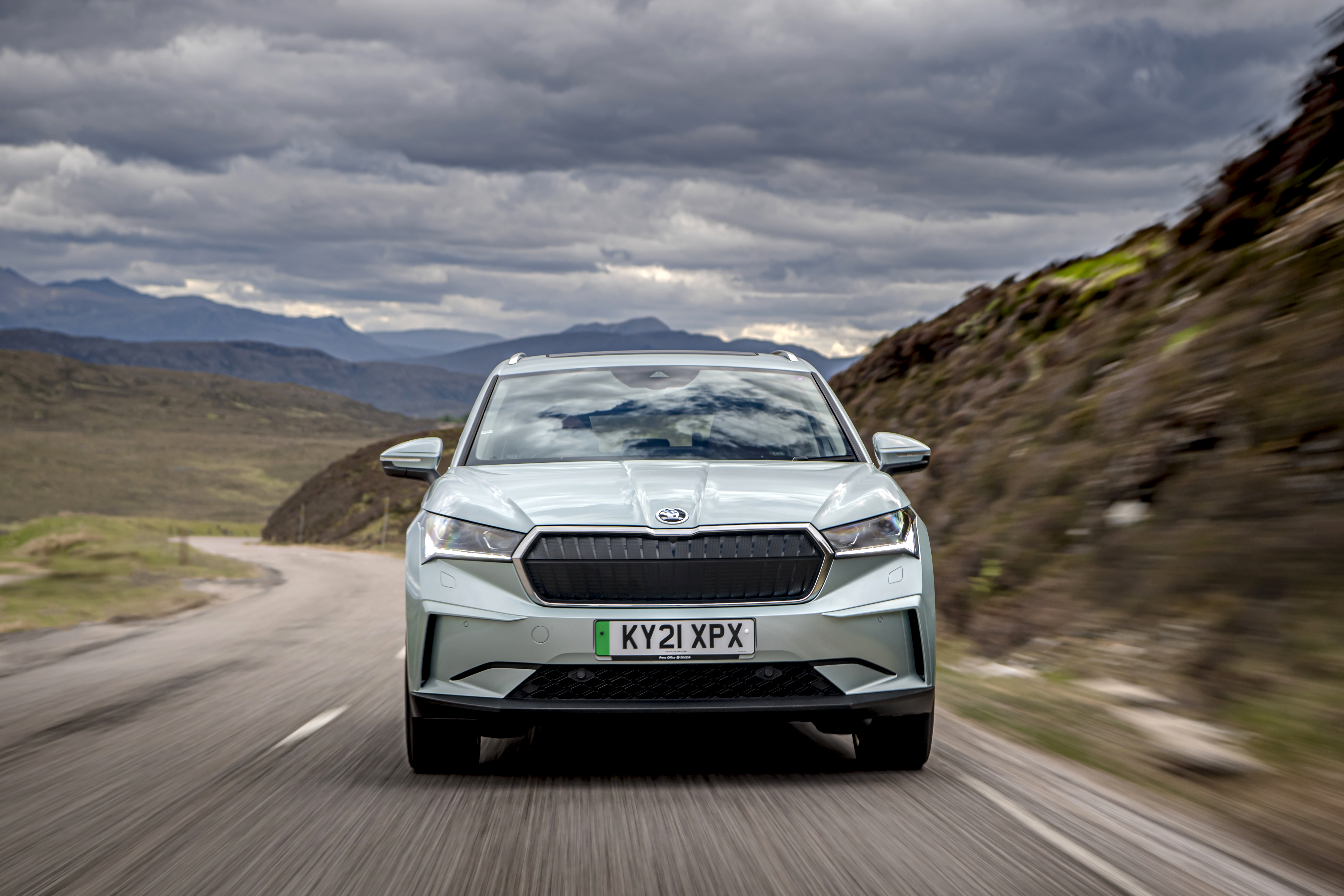 Škoda Enyaq IV 80 Electric SUV on mountain road HD Wallpaper