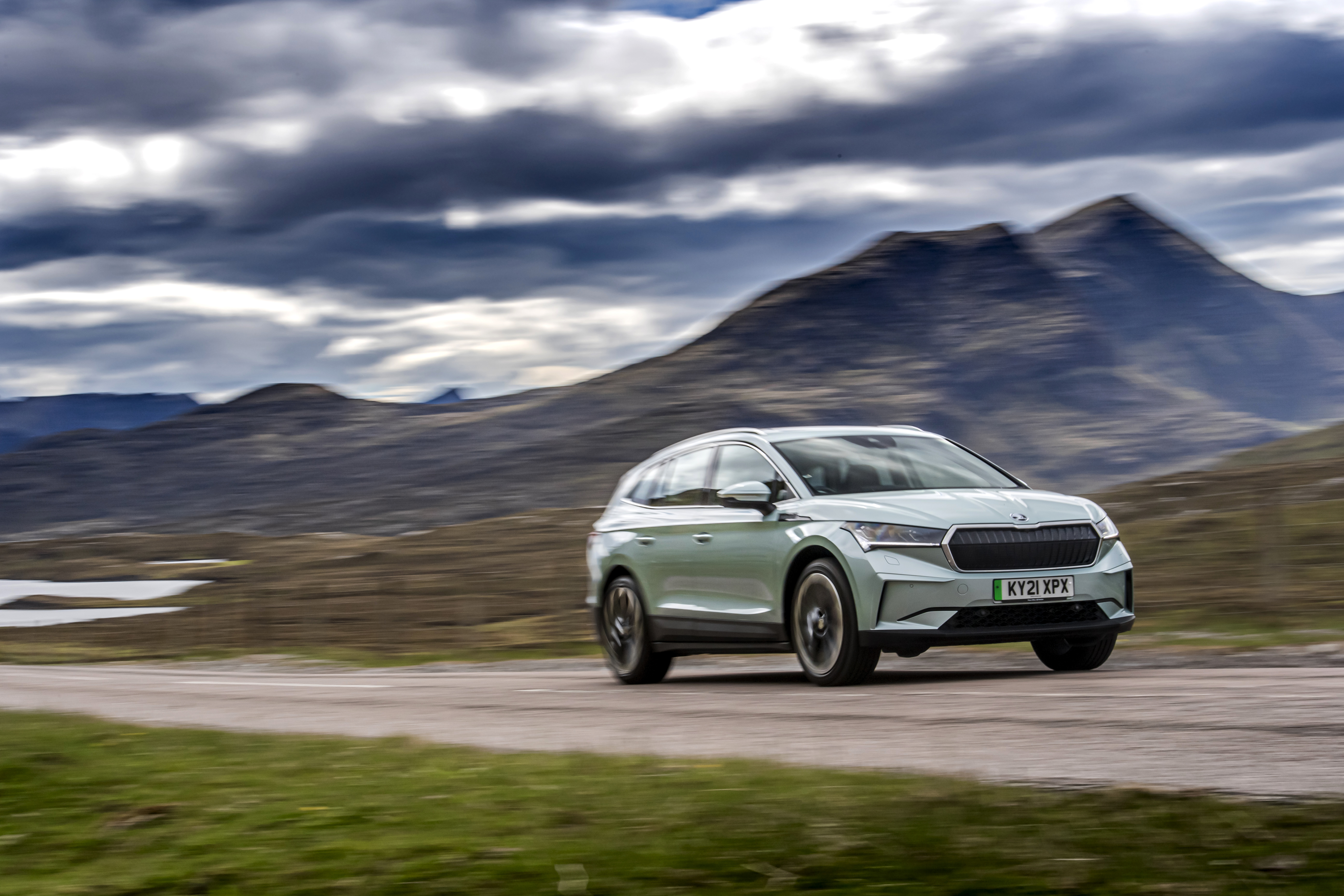 Škoda Enyaq electric SUV driving in mountains HD Wallpaper
