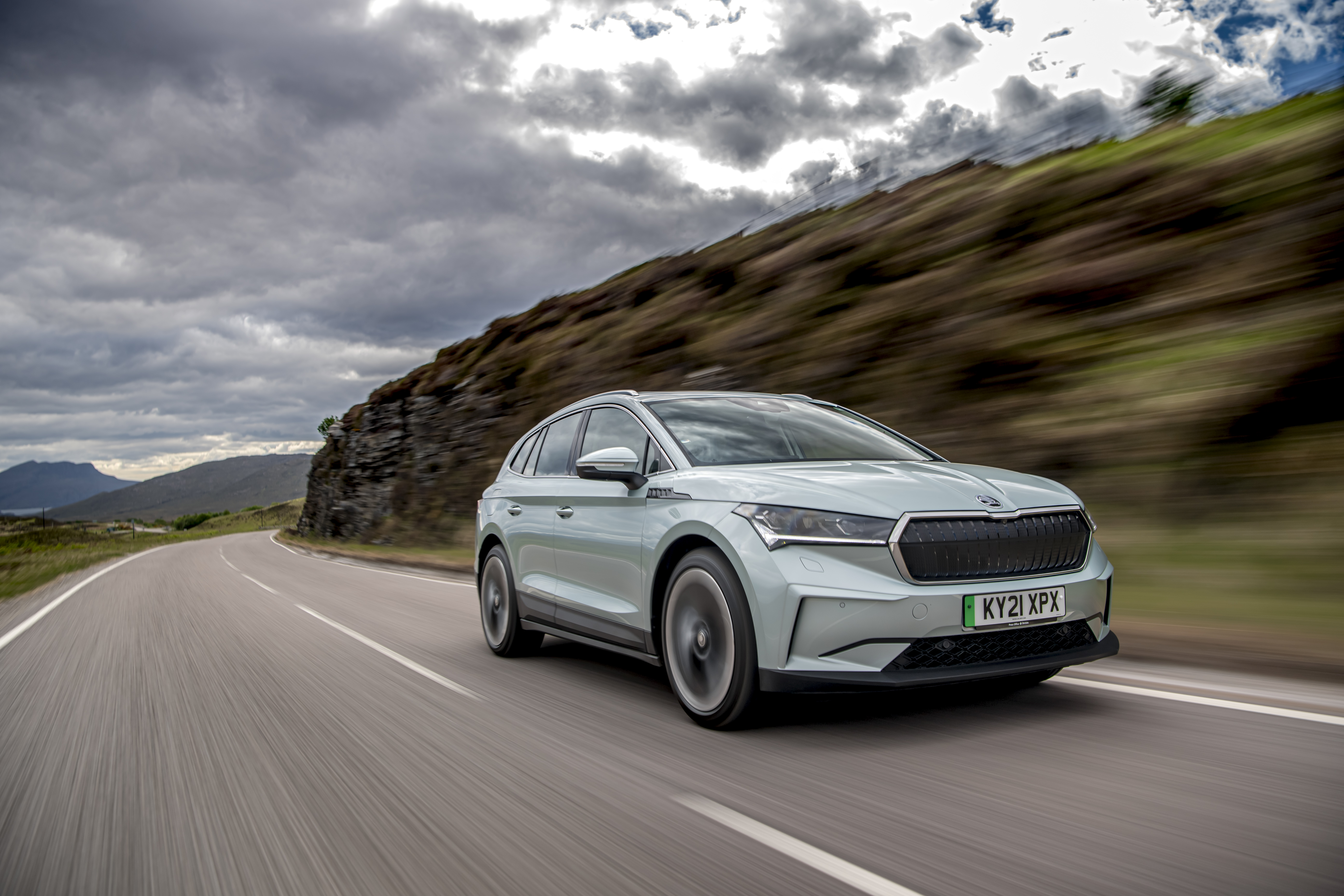 Škoda Enyaq IV 80 Electric SUV on a scenic road HD Wallpaper