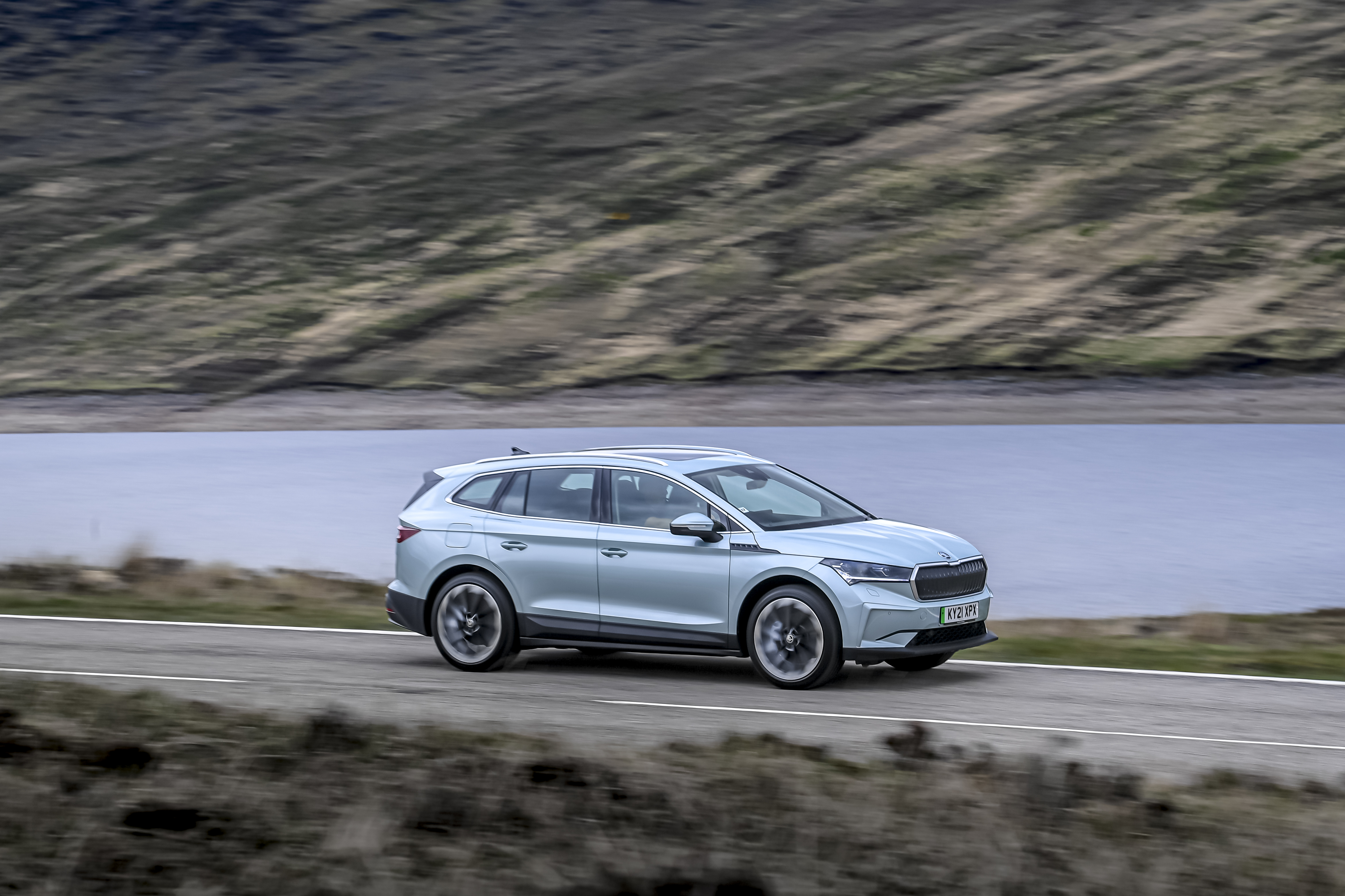 Škoda Enyaq iV 80 electric SUV driving by a lake HD Wallpaper