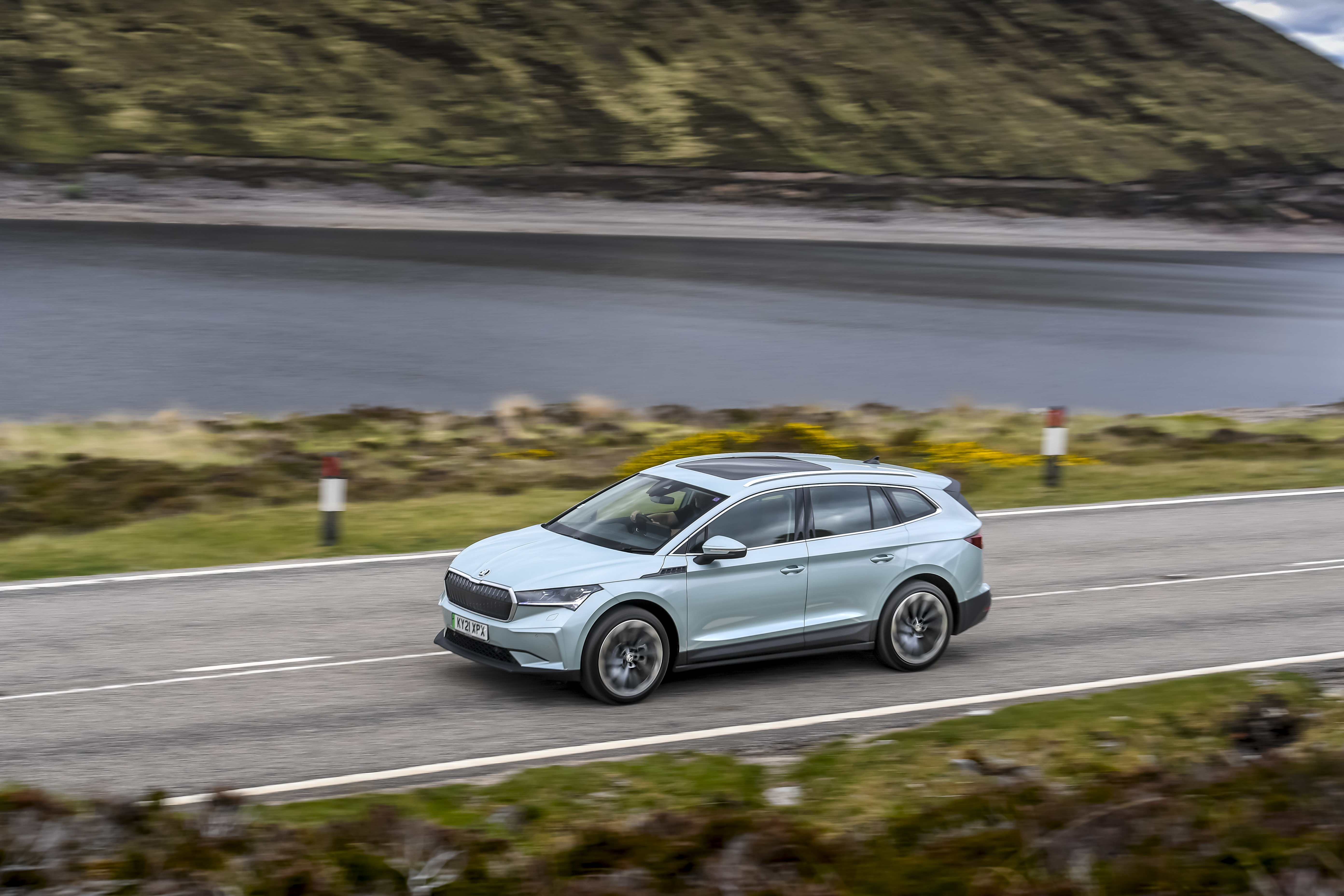Škoda Enyaq IV 80 Electric SUV driving by a lake HD Wallpaper