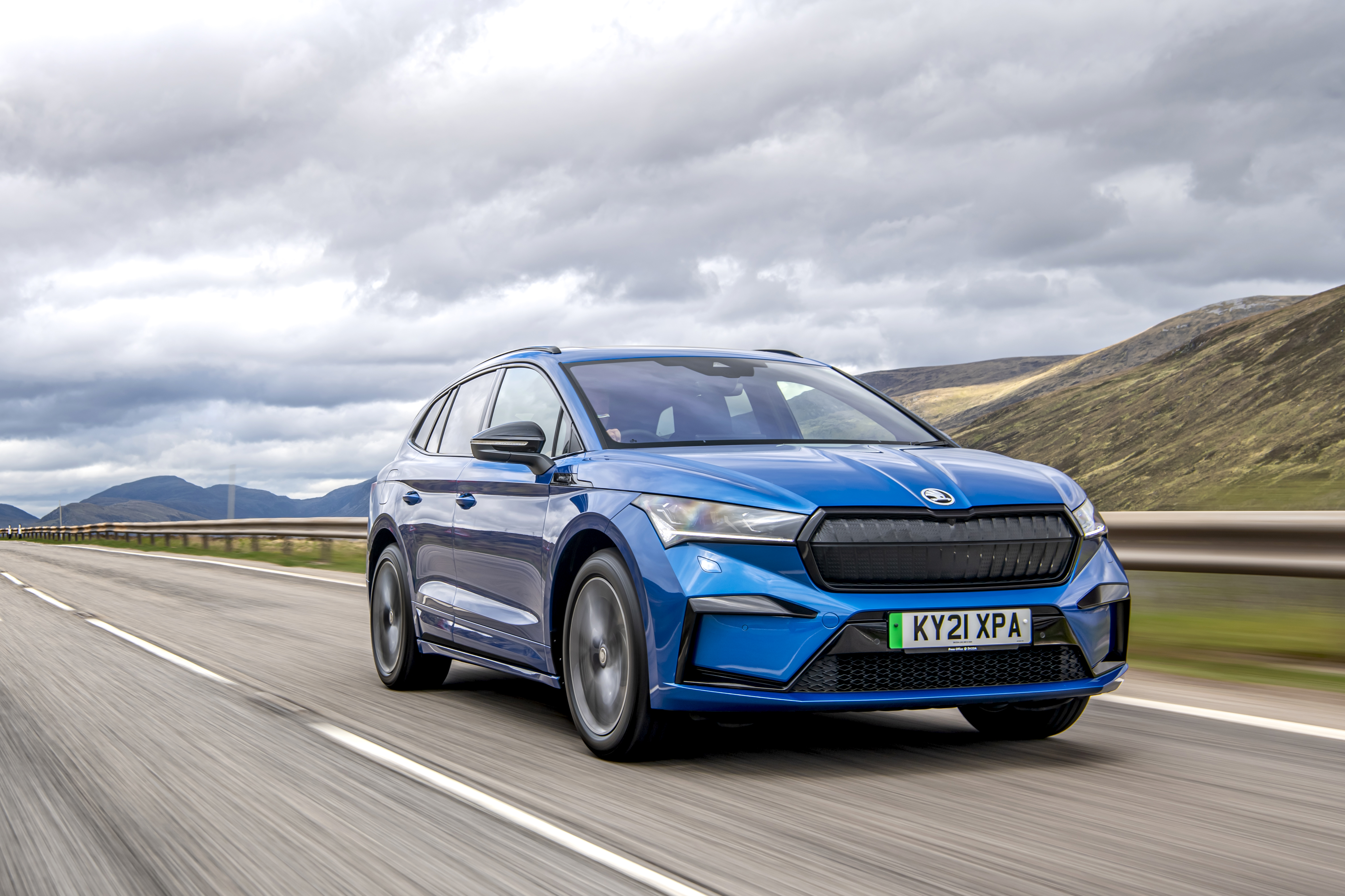 Blue Škoda Enyaq Sportline iV 80 Electric SUV on highway HD Wallpaper