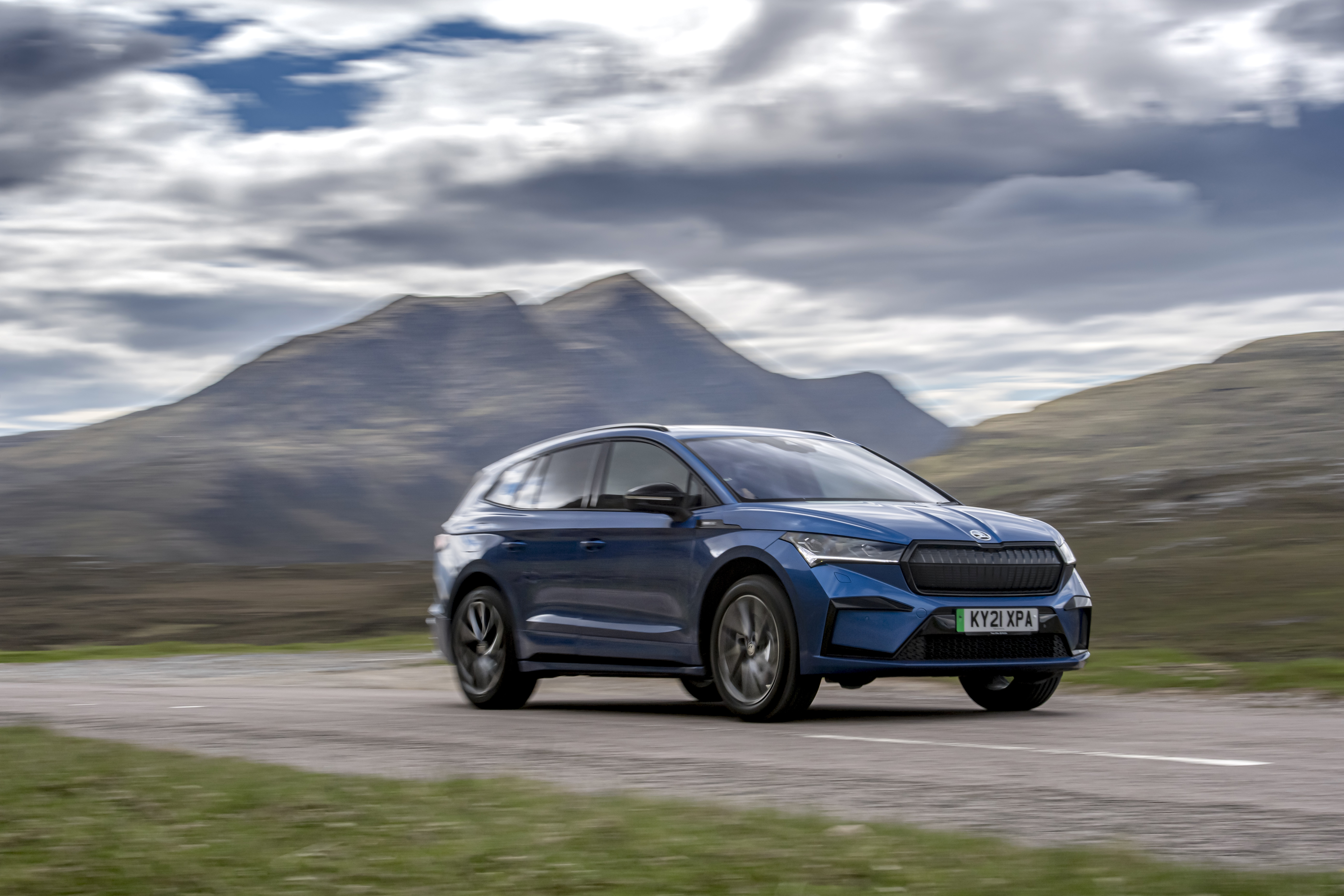 Blue Škoda Enyaq Electric SUV driving in mountains HD Wallpaper