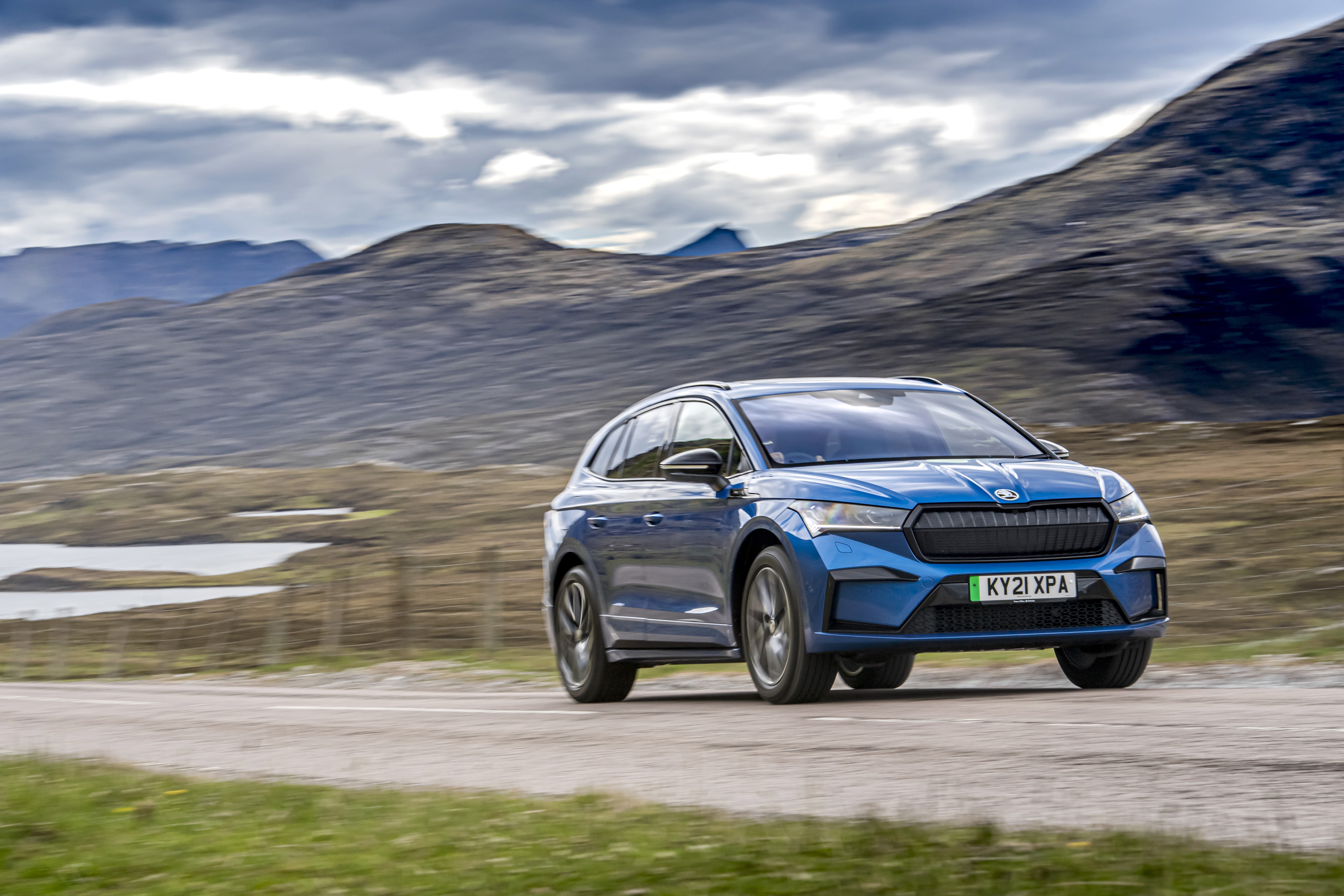 Blue Škoda Enyaq Sportline iV 80 SUV on a scenic road HD Wallpaper