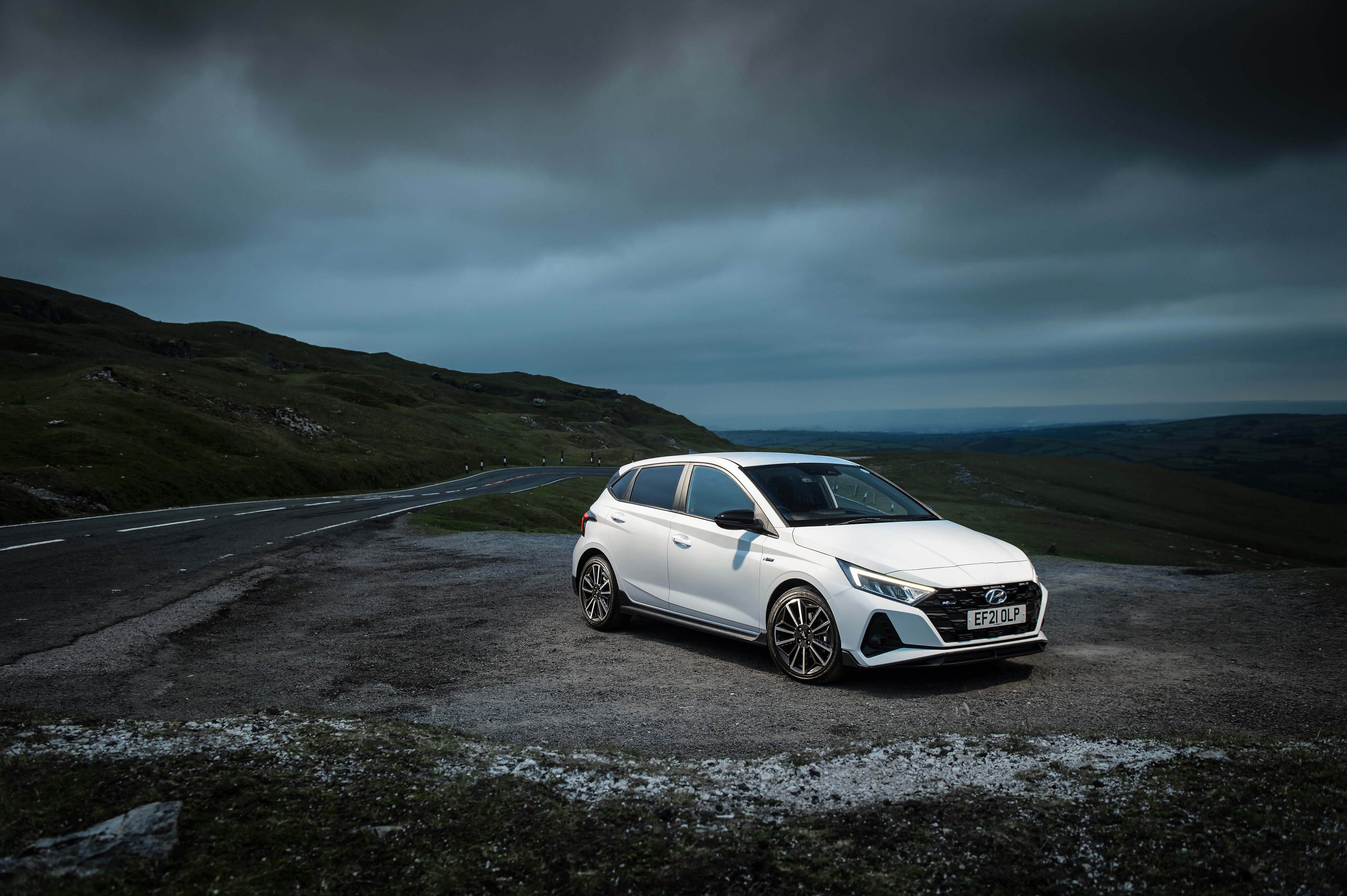 White Hyundai i20 N Line on a mountain road HD Wallpaper