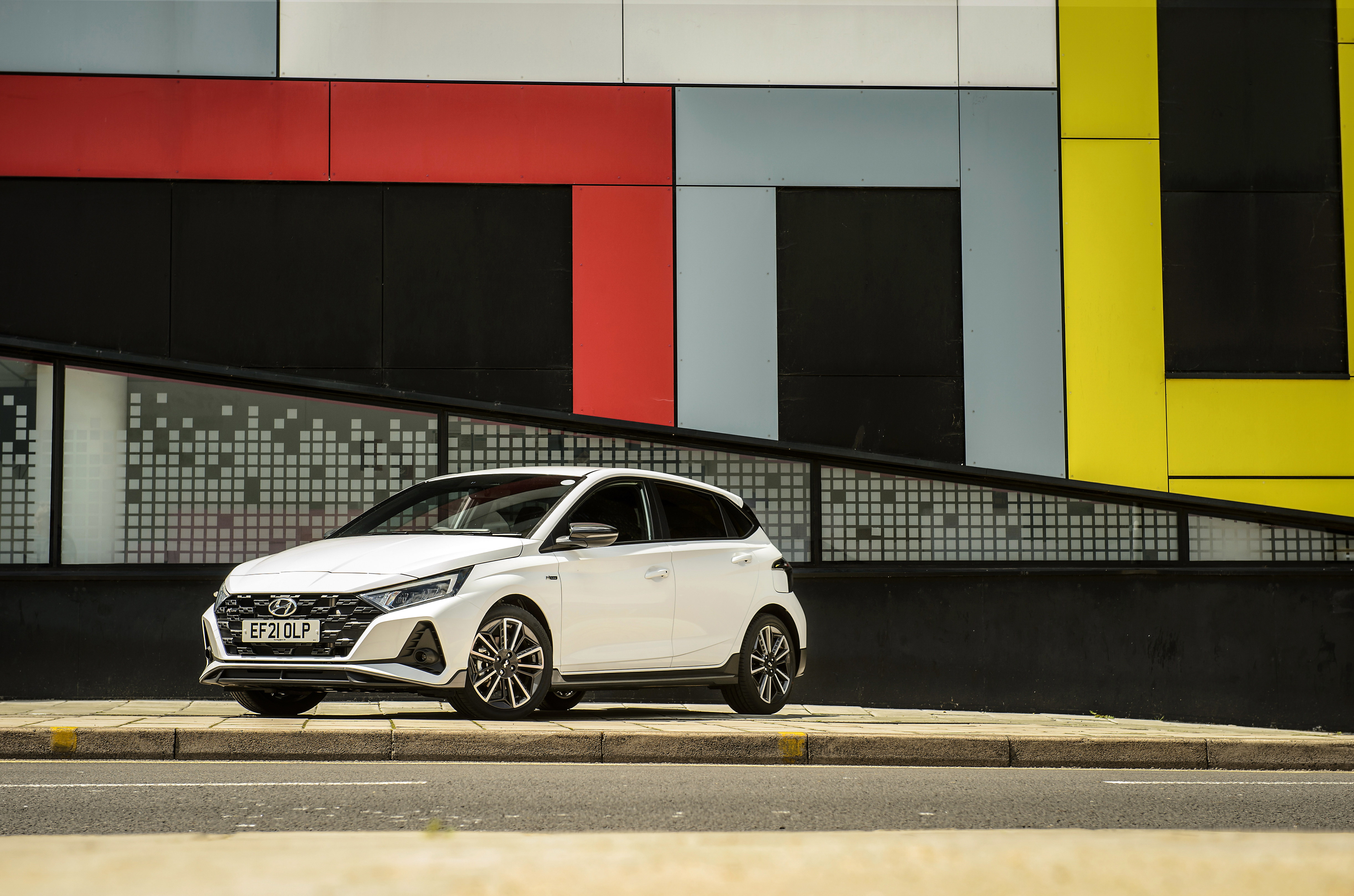 White Hyundai i20 N Line parked against a colorful wall HD Wallpaper
