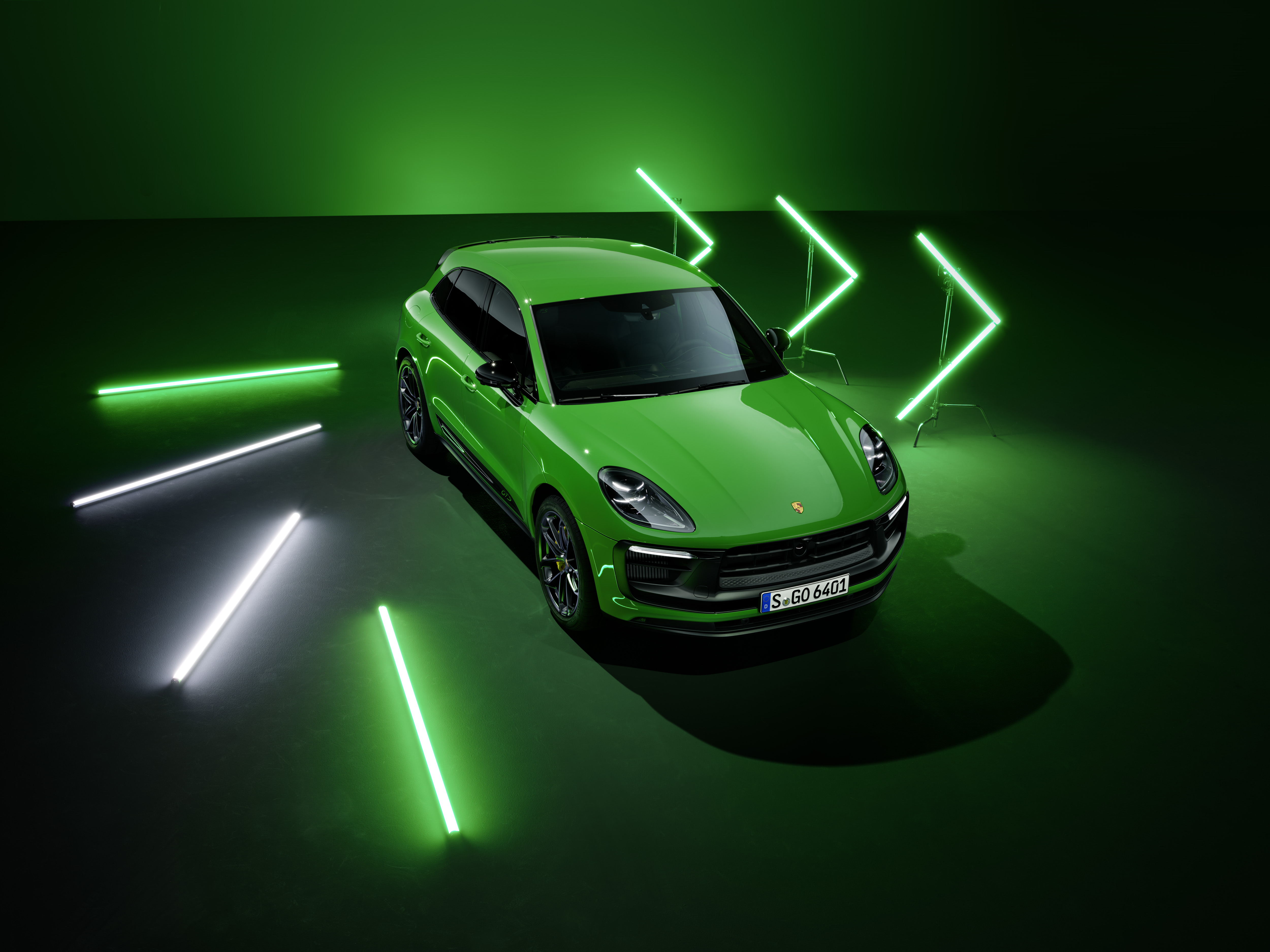 Green Porsche Macan GTS in a neon-lit studio HD Wallpaper