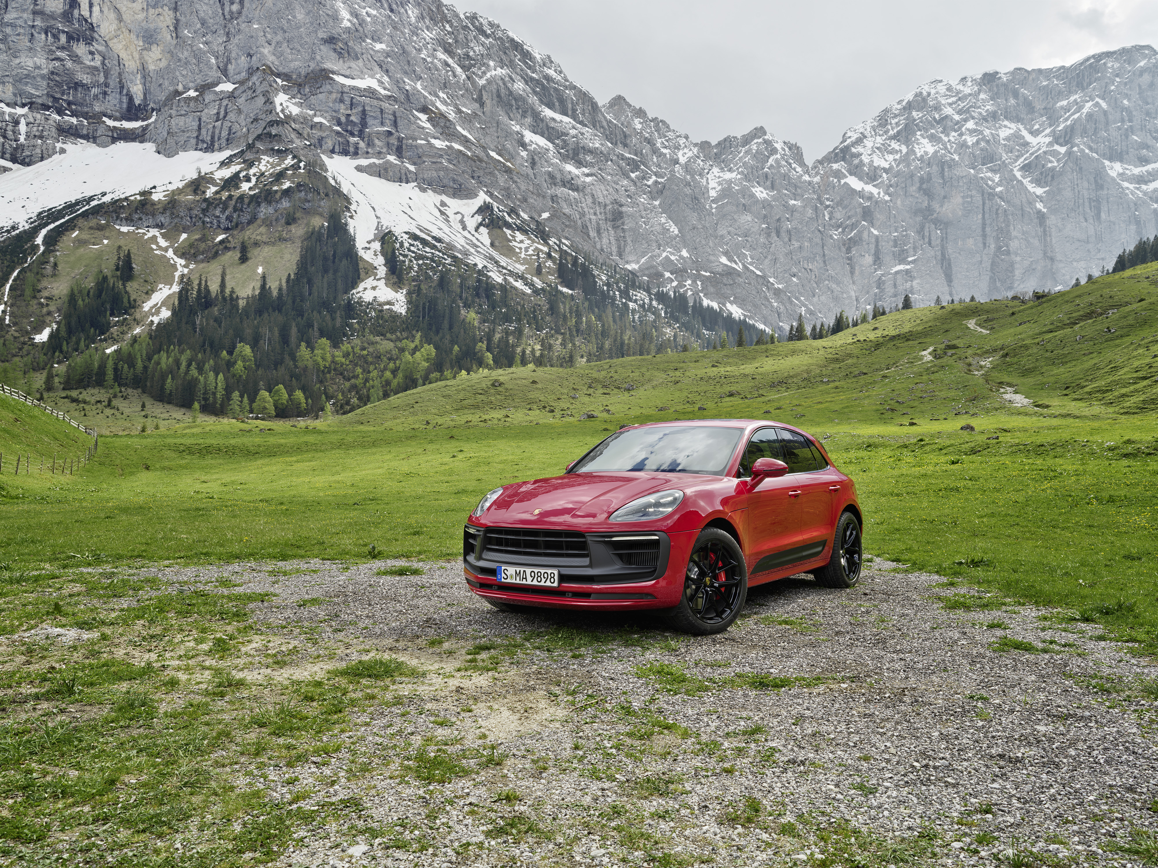 Red Porsche Macan GTS SUV in a scenic mountain landscape HD Wallpaper