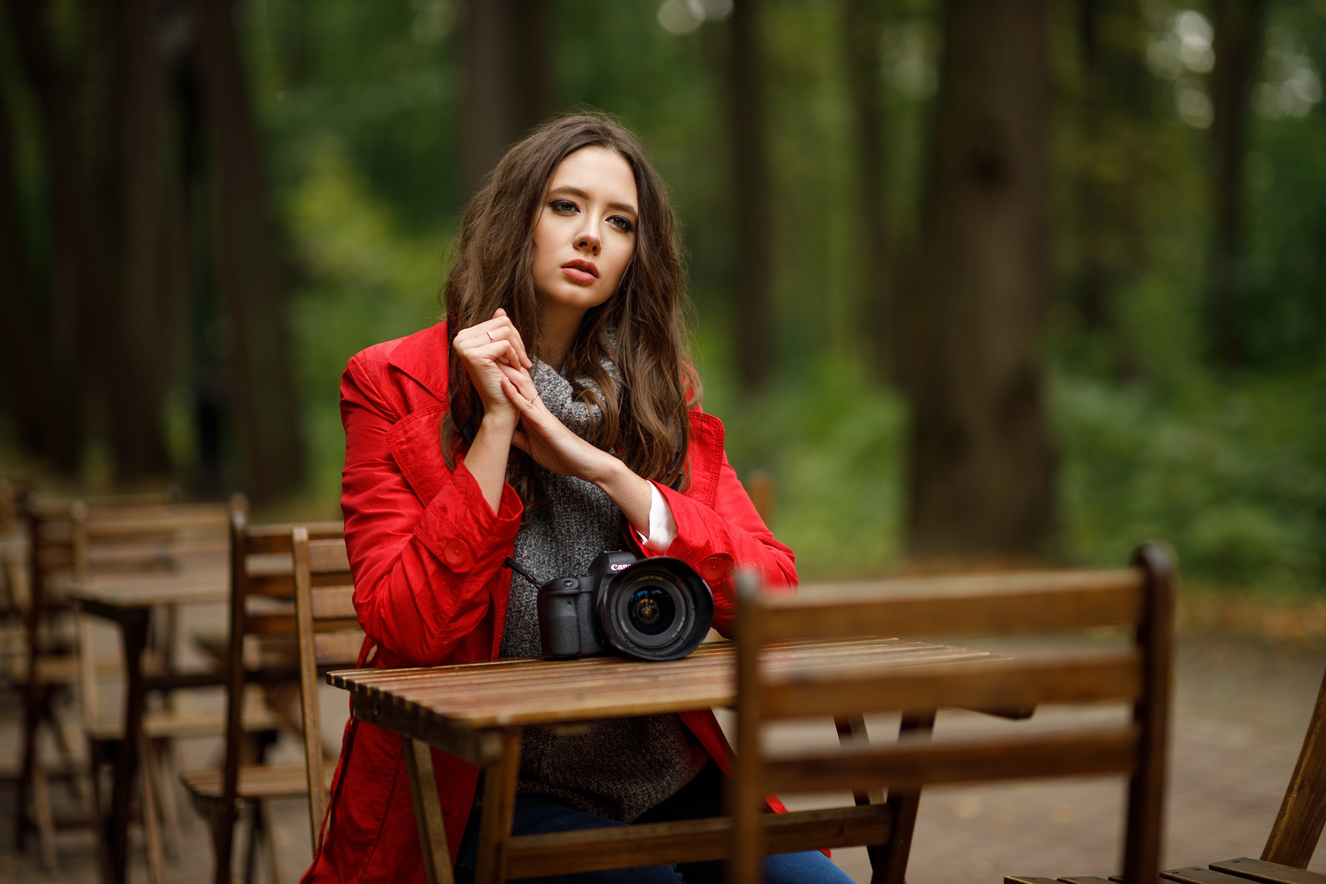 Brunette model in red coat with camera outdoors HD Wallpaper