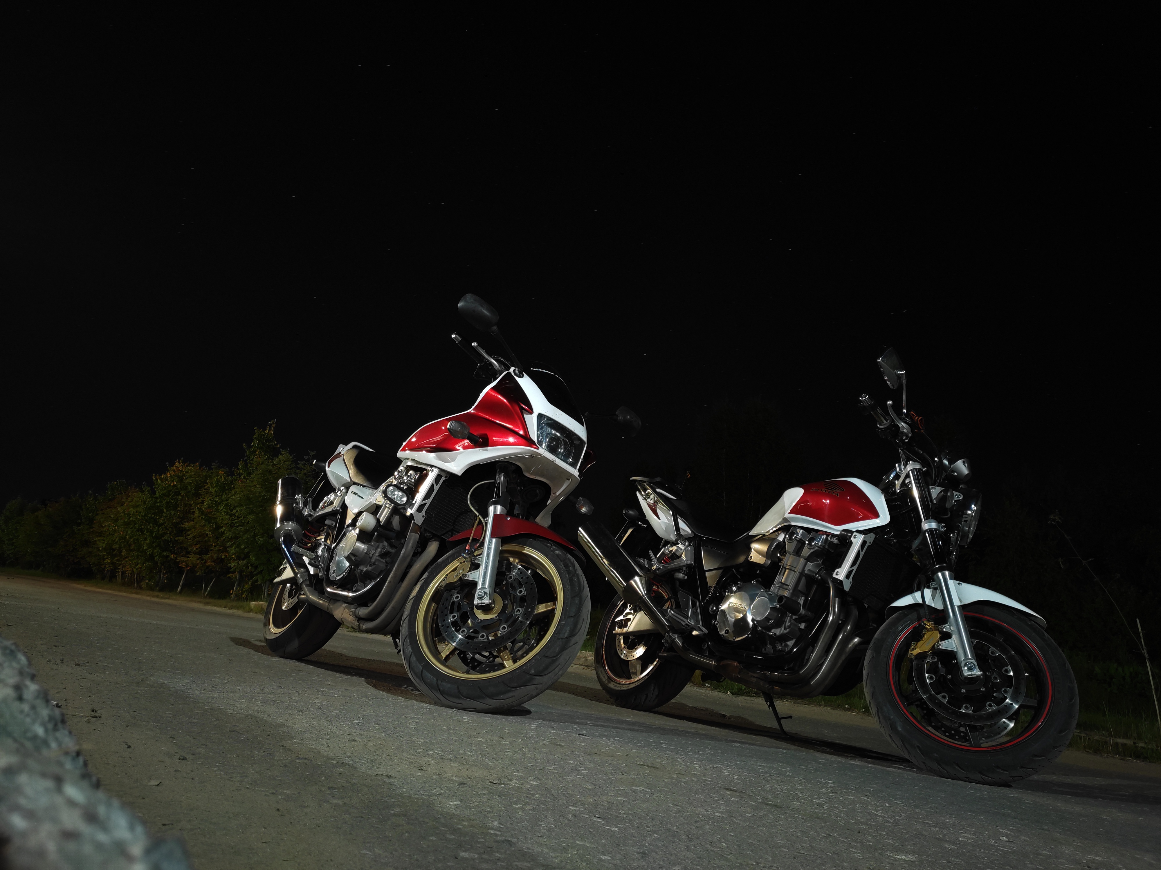 Honda CB1300 motorcycles under a starry night sky HD Wallpaper