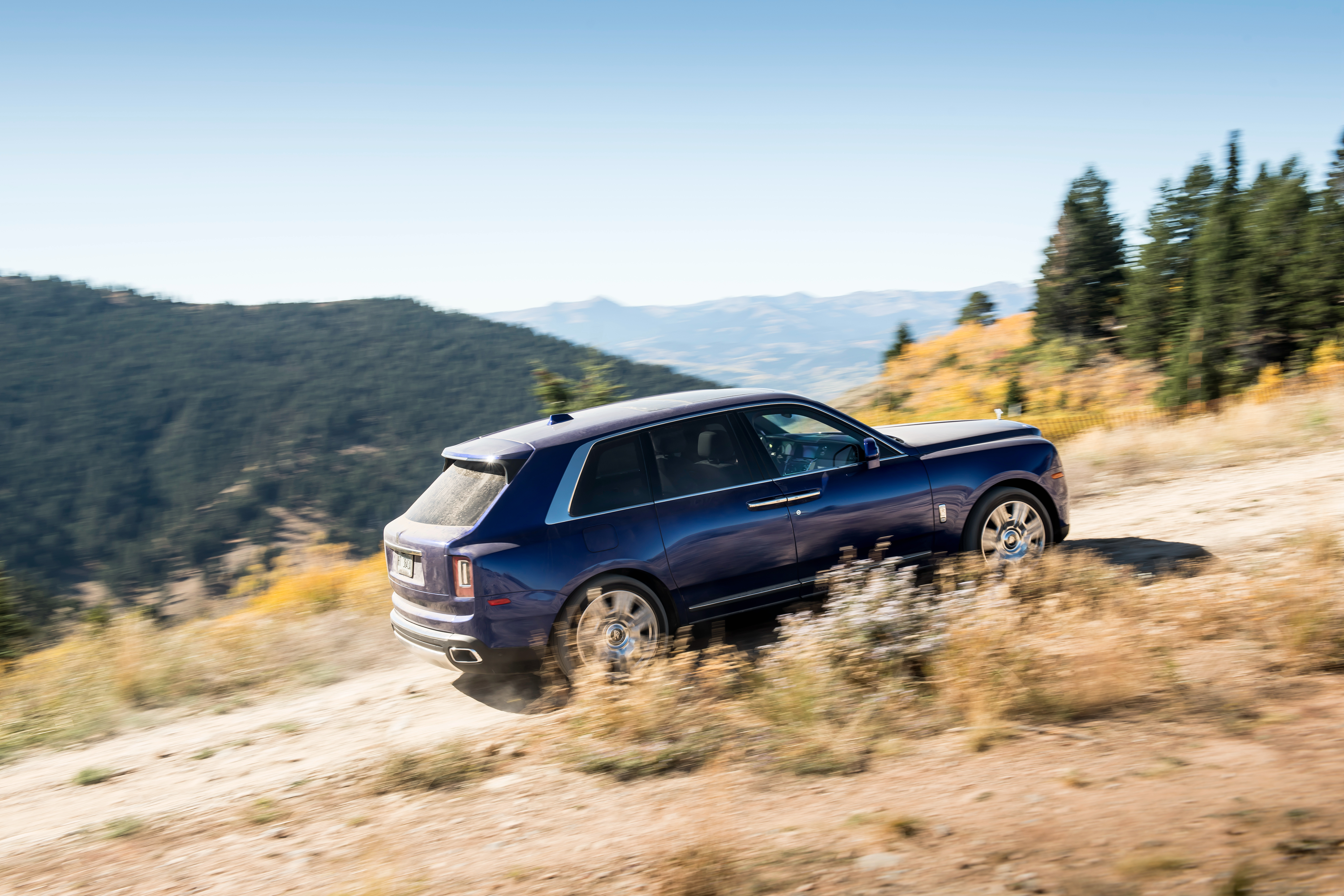 Luxury Rolls-Royce Cullinan SUV off-road in autumn mountains HD Wallpaper