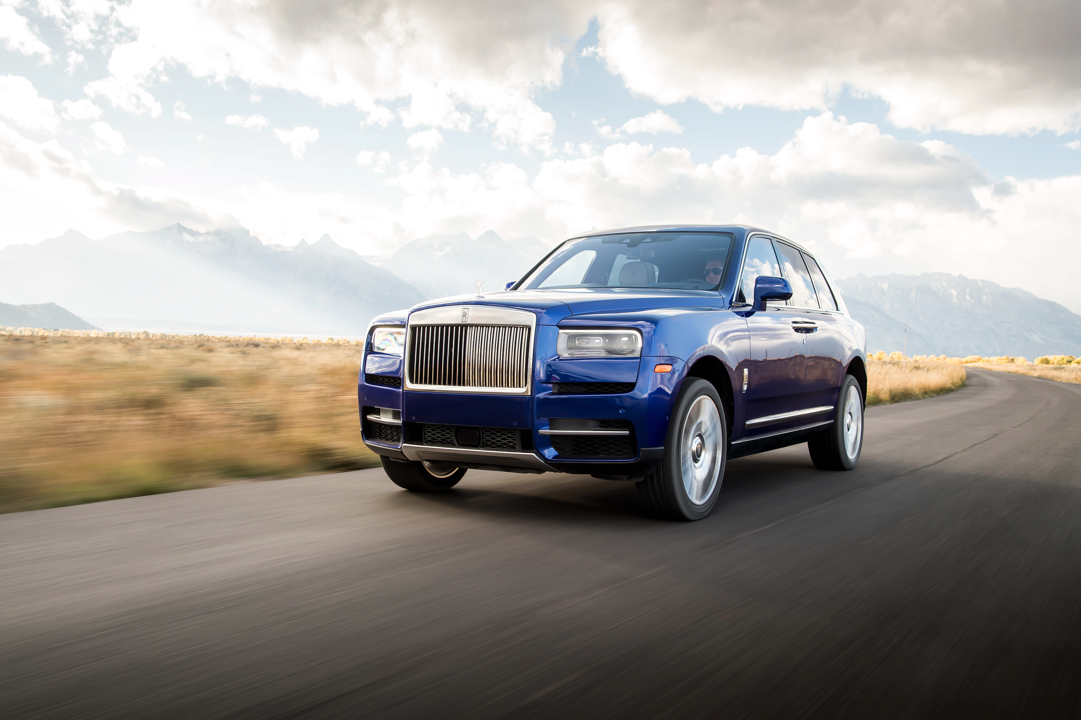 Rolls-Royce Cullinan 4K luxury SUV driving on a mountain road HD Wallpaper