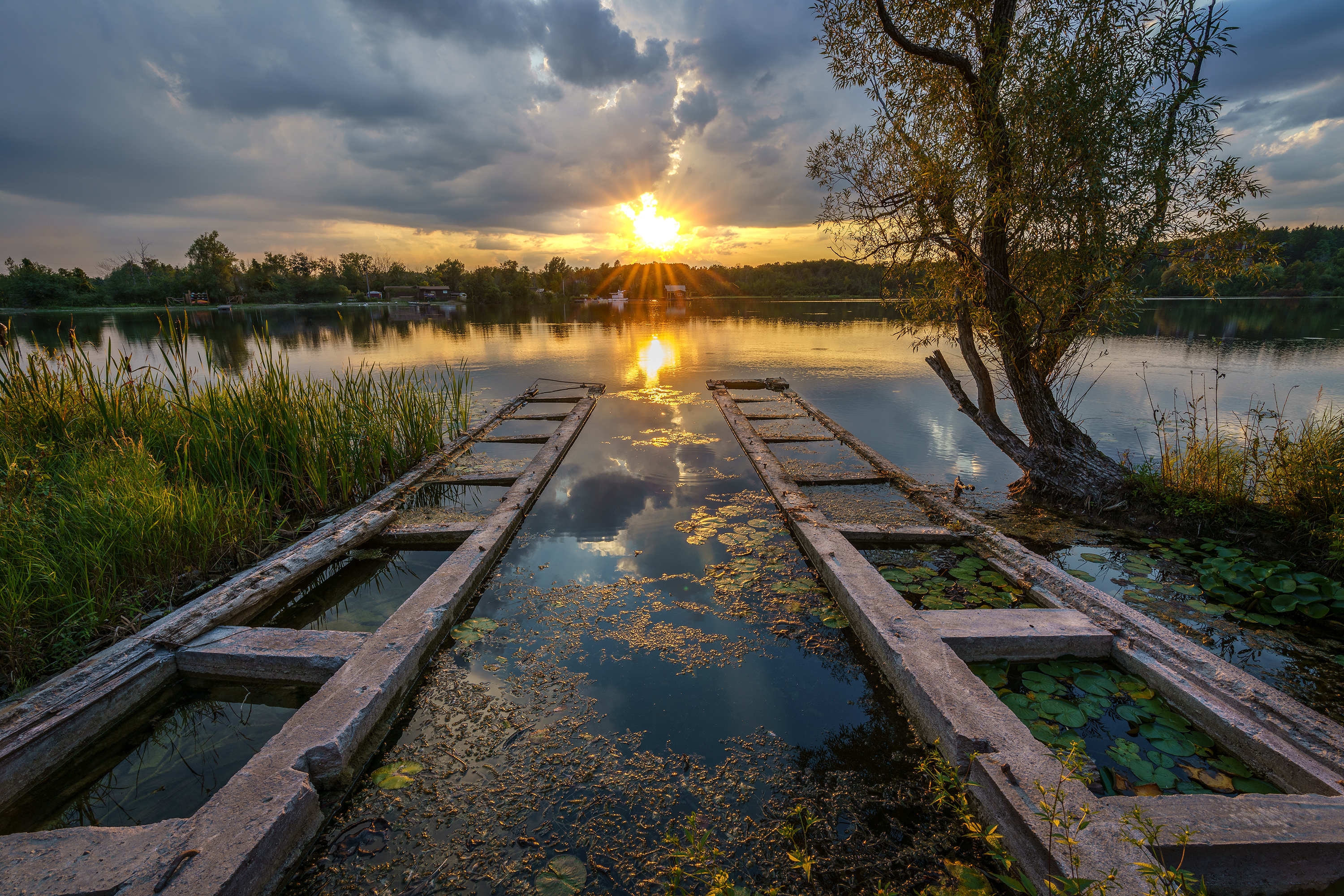 Vibrant Lake Sunset with Concrete Ramps HD Wallpaper