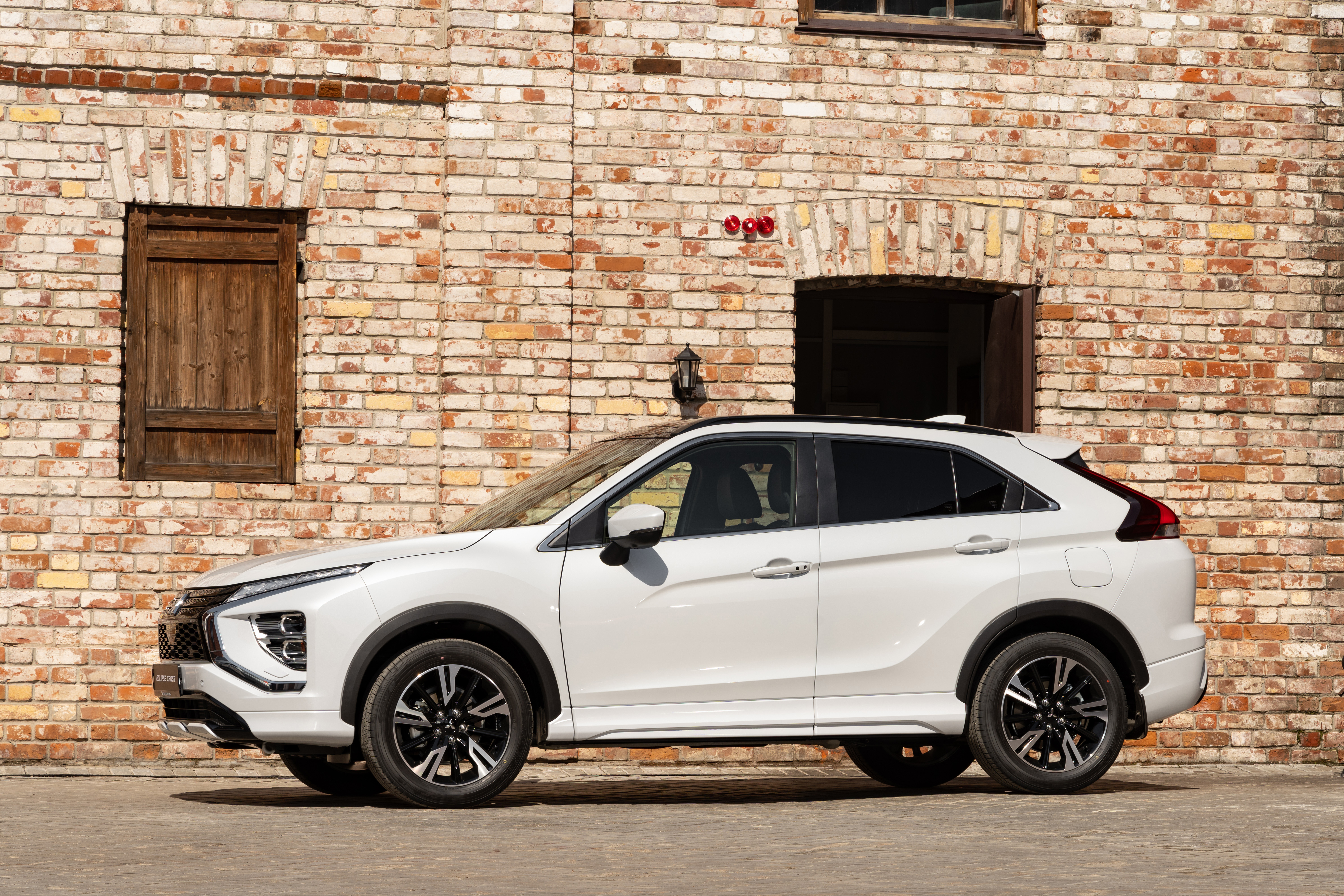 White Mitsubishi Eclipse Cross SUV by brick wall HD Wallpaper