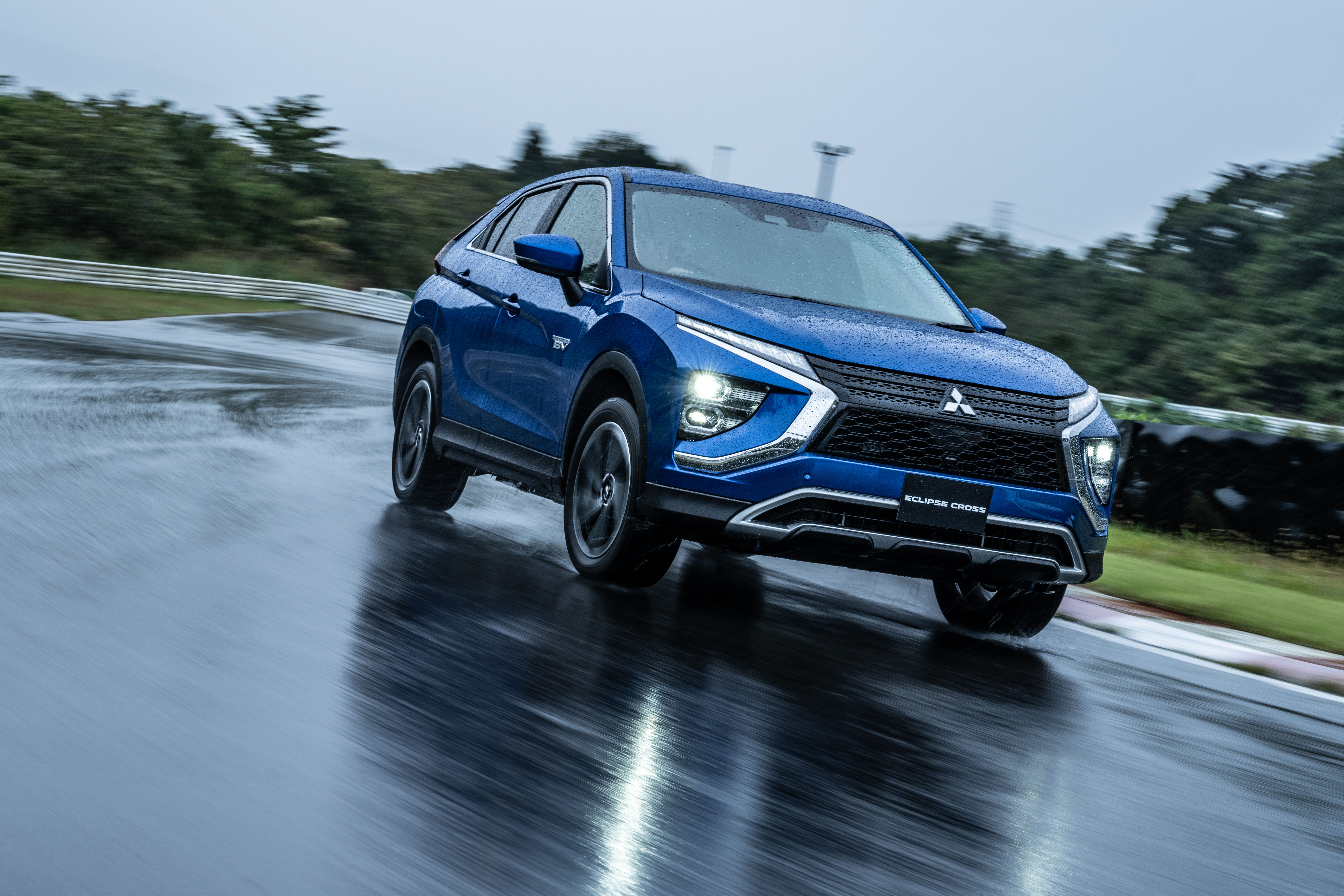 Mitsubishi Eclipse Cross SUV driving in rain on track 4K HD Wallpaper