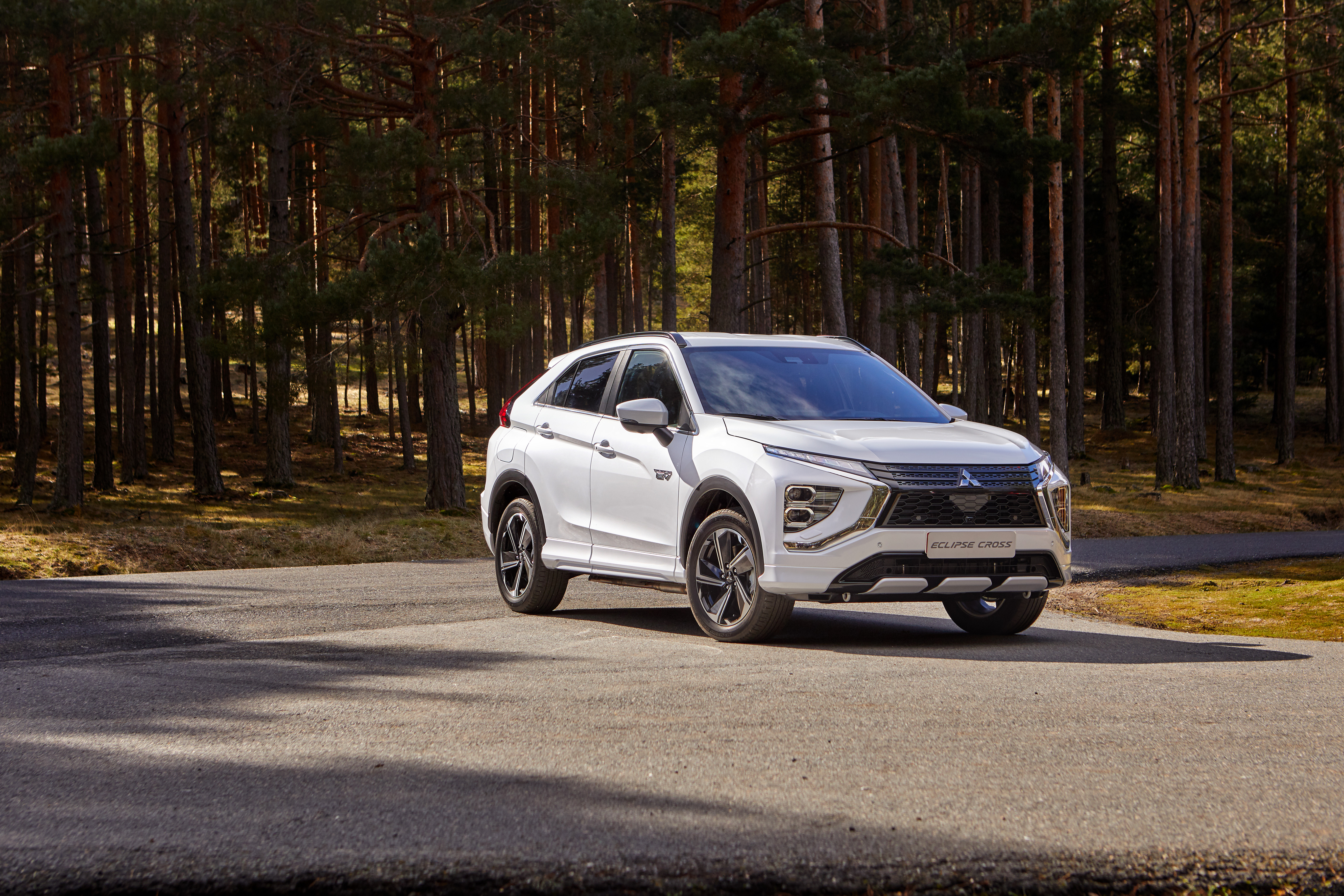 White Mitsubishi Eclipse Cross SUV in a forest HD Wallpaper