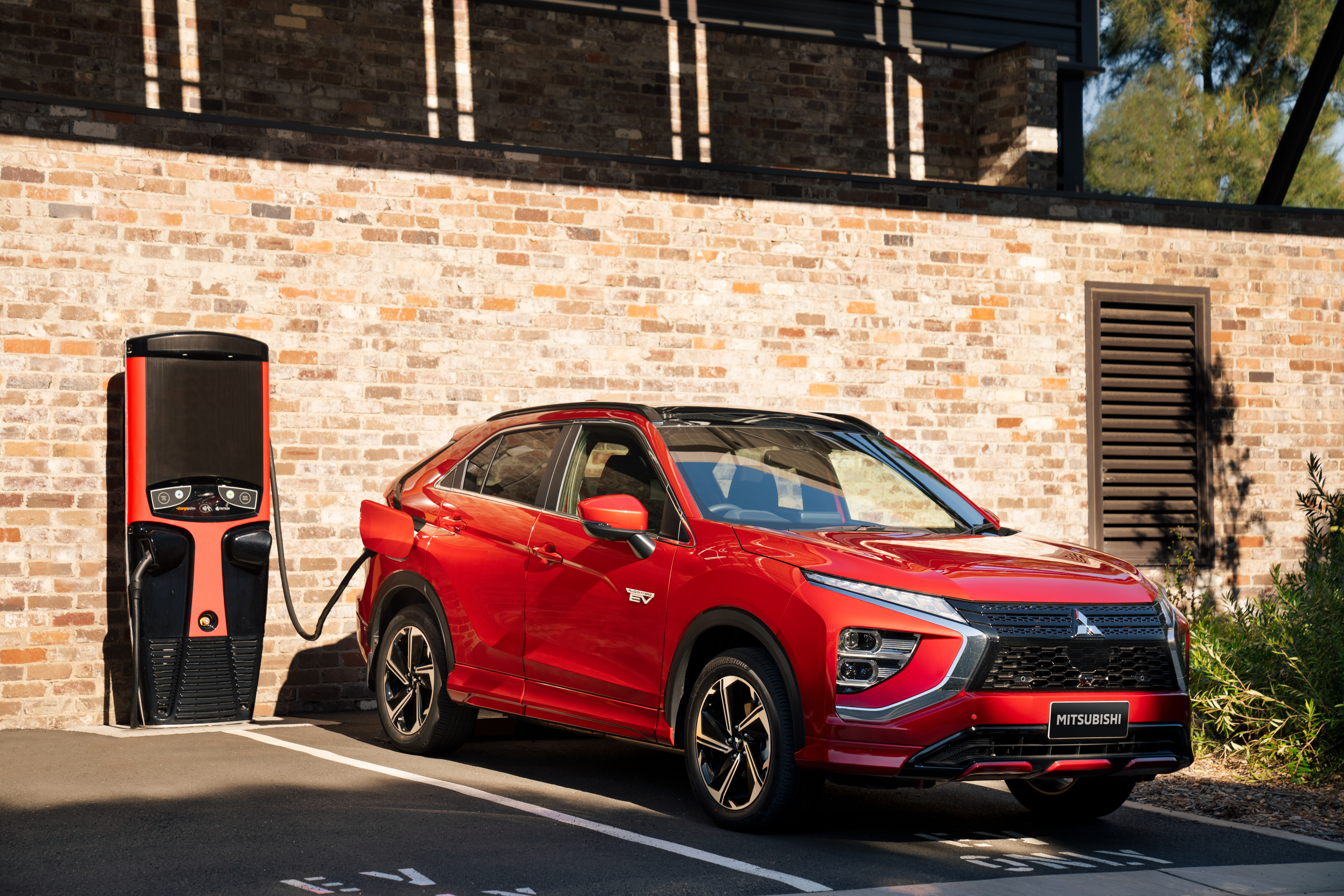 Red Mitsubishi Eclipse Cross PHEV SUV charging HD Wallpaper
