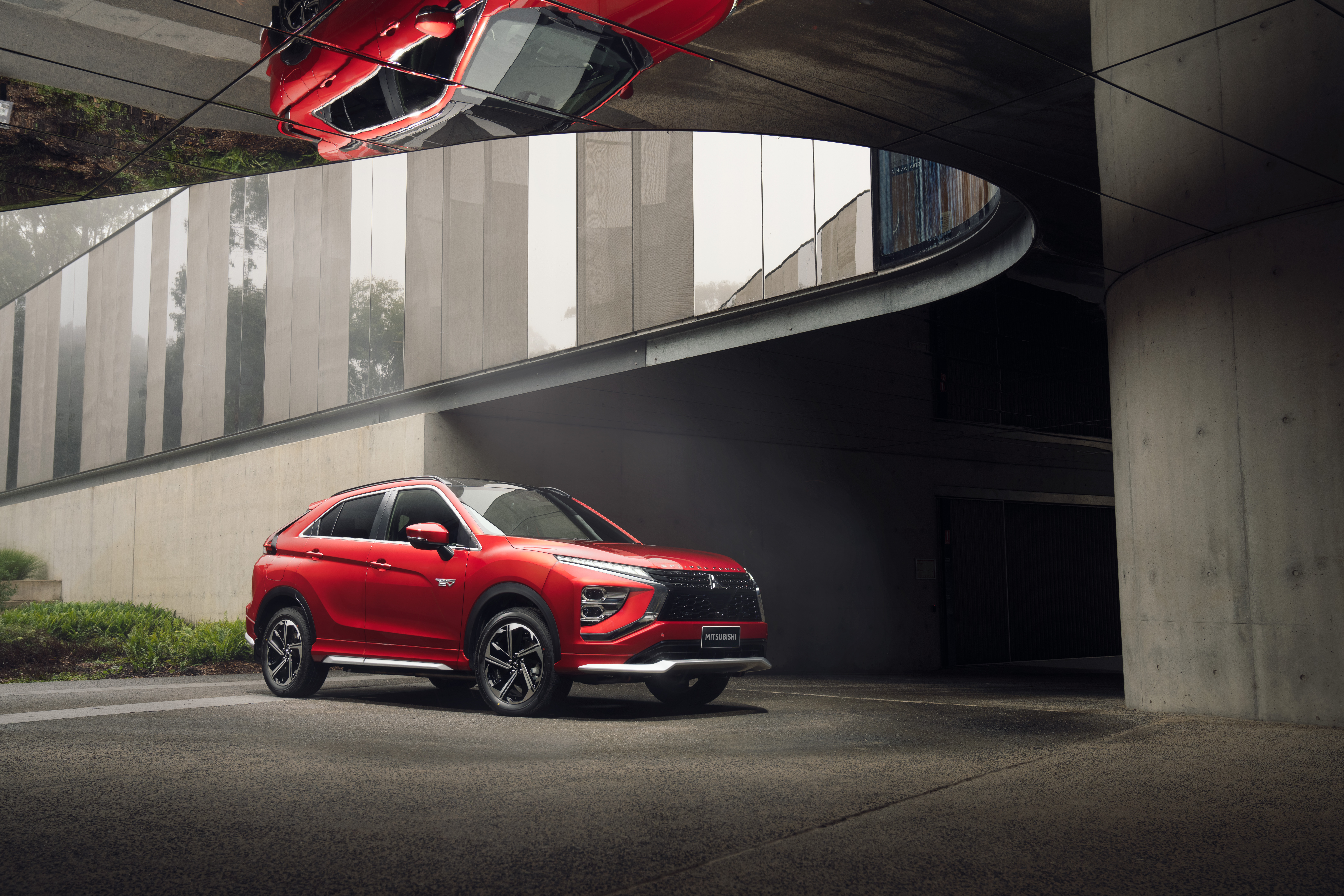 Red Mitsubishi Eclipse Cross PHEV SUV with overhead reflection HD Wallpaper