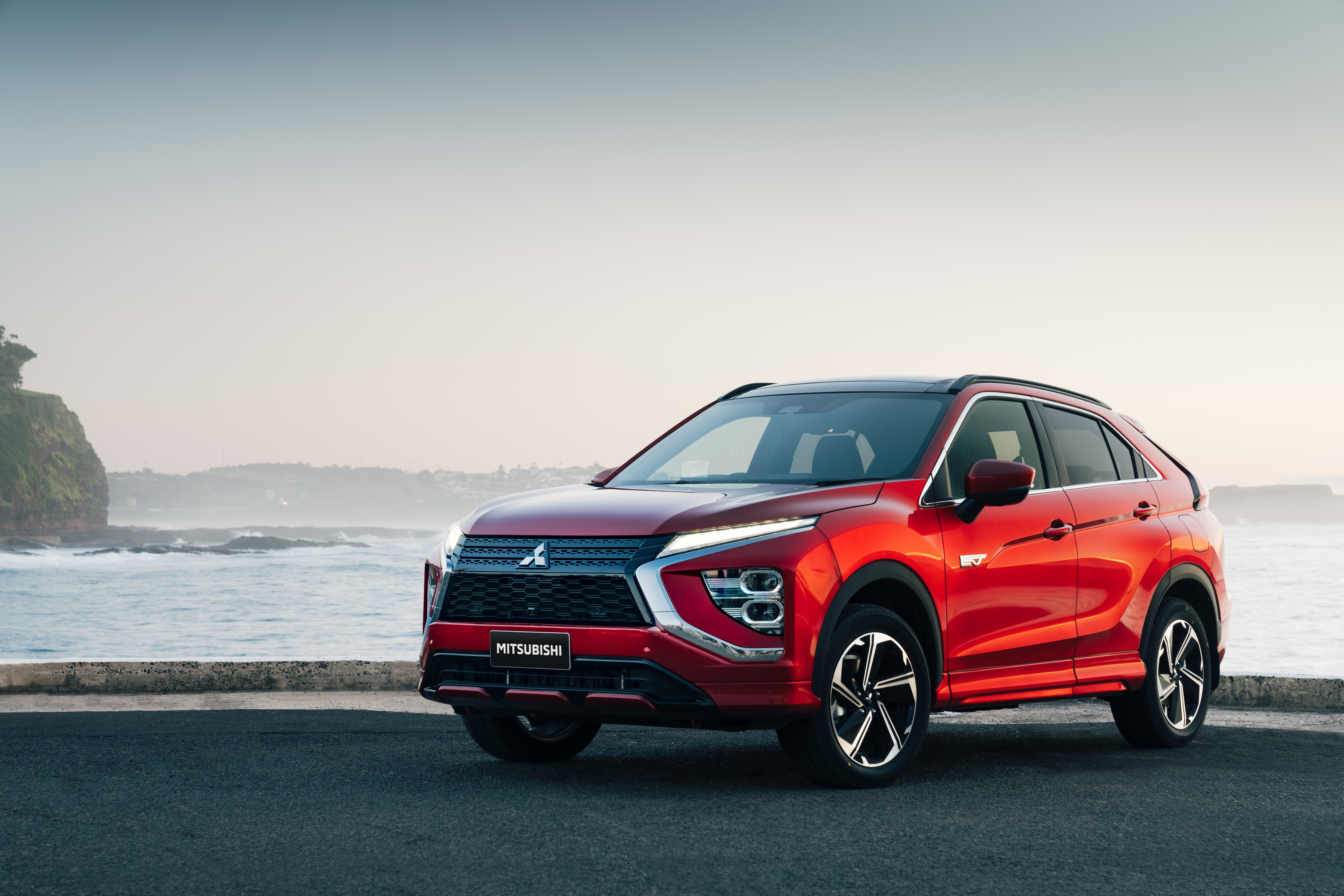 Red 2021 Mitsubishi Eclipse Cross PHEV SUV by the ocean HD Wallpaper