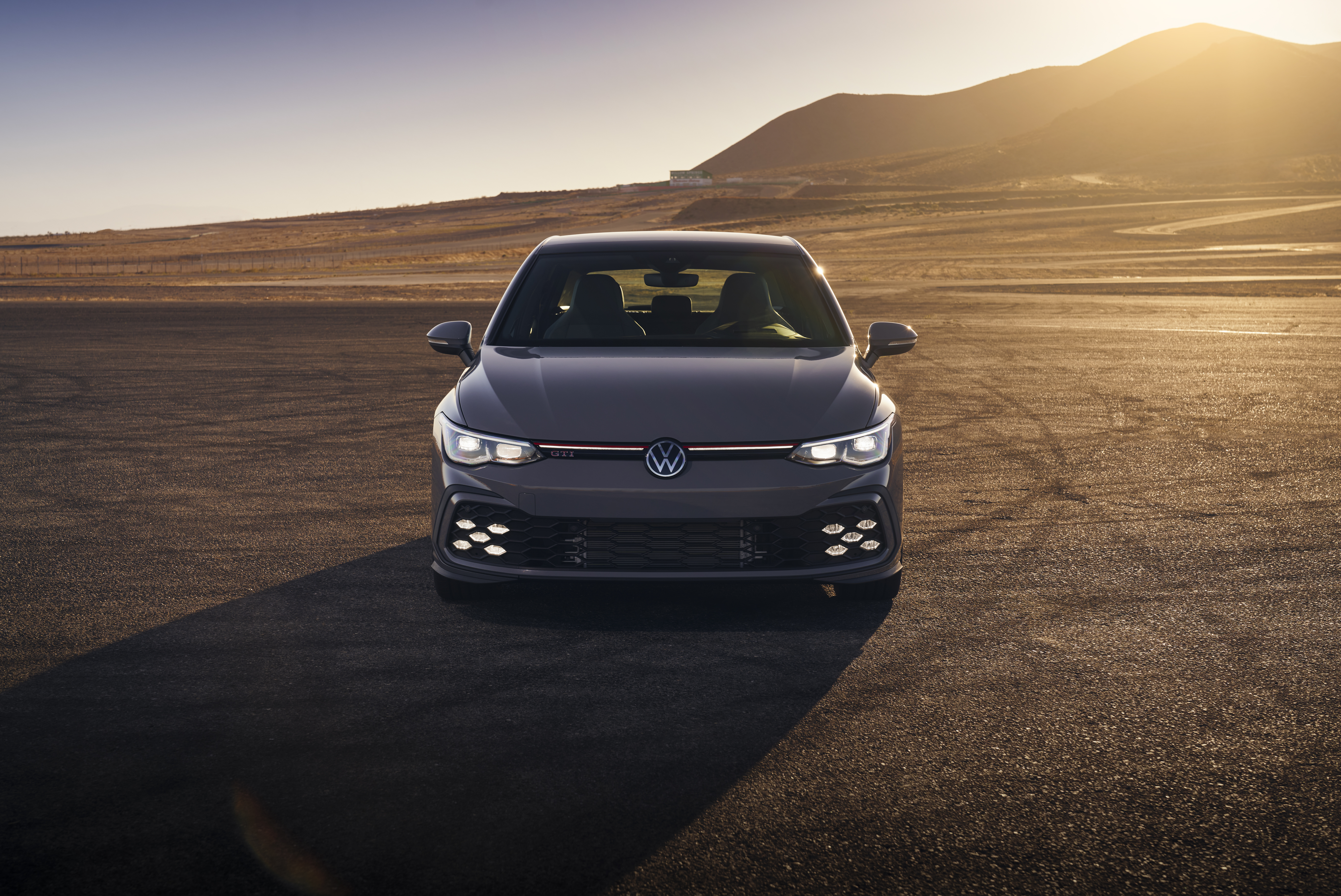 Volkswagen Golf GTI in desert at sunset HD Wallpaper