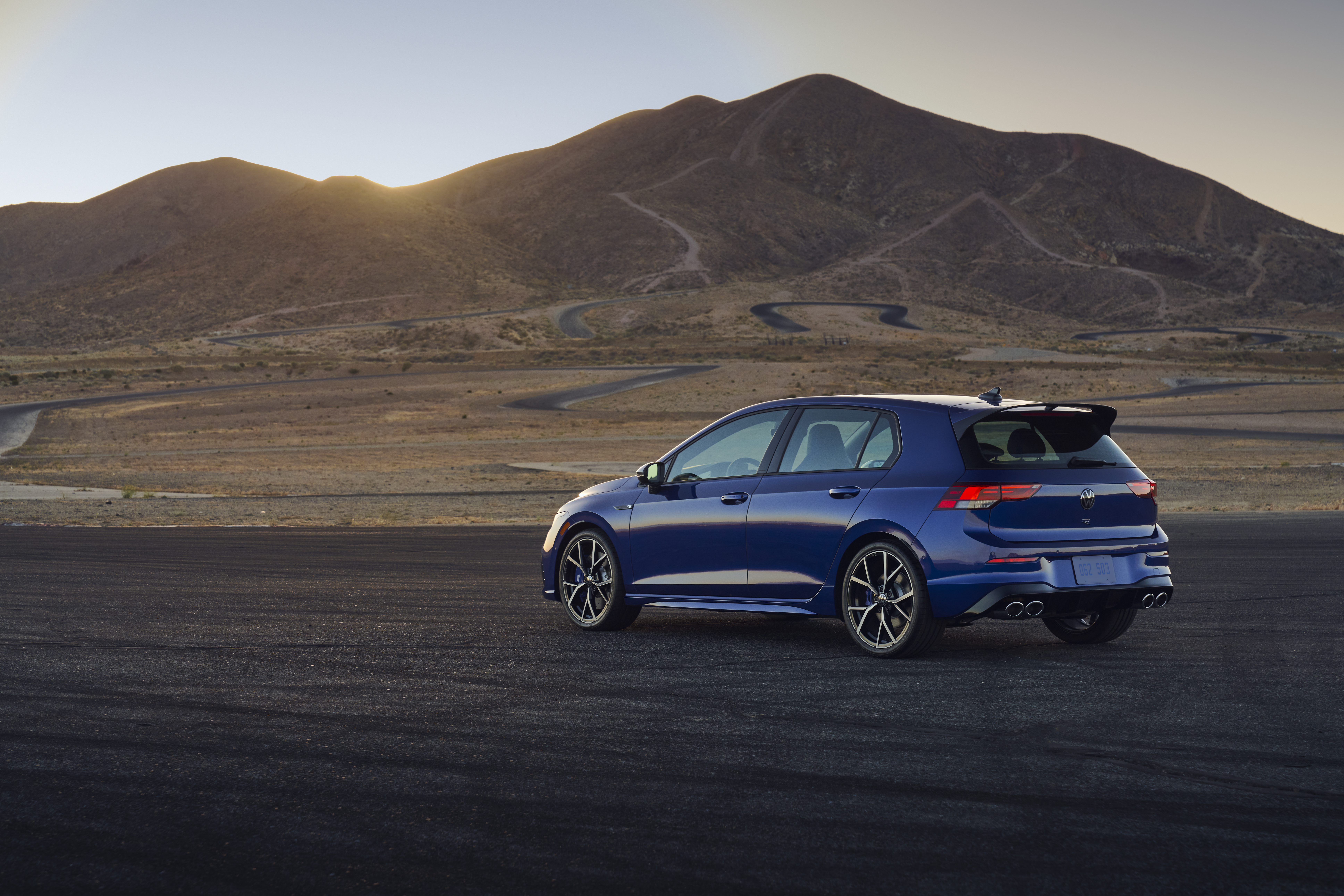 Blue 2022 Volkswagen Golf R on a winding desert track HD Wallpaper