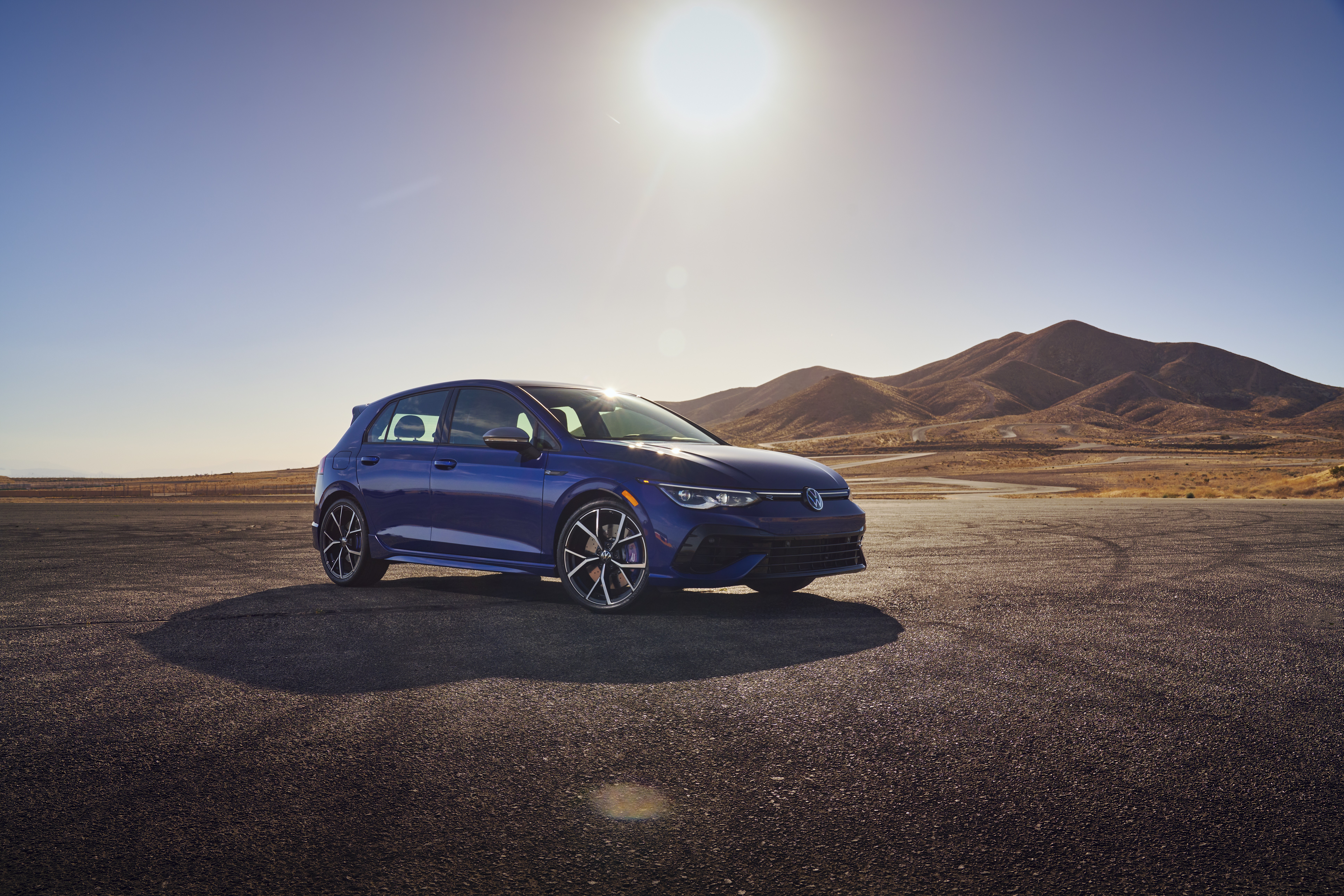 Blue 2022 Volkswagen Golf R in desert landscape HD Wallpaper