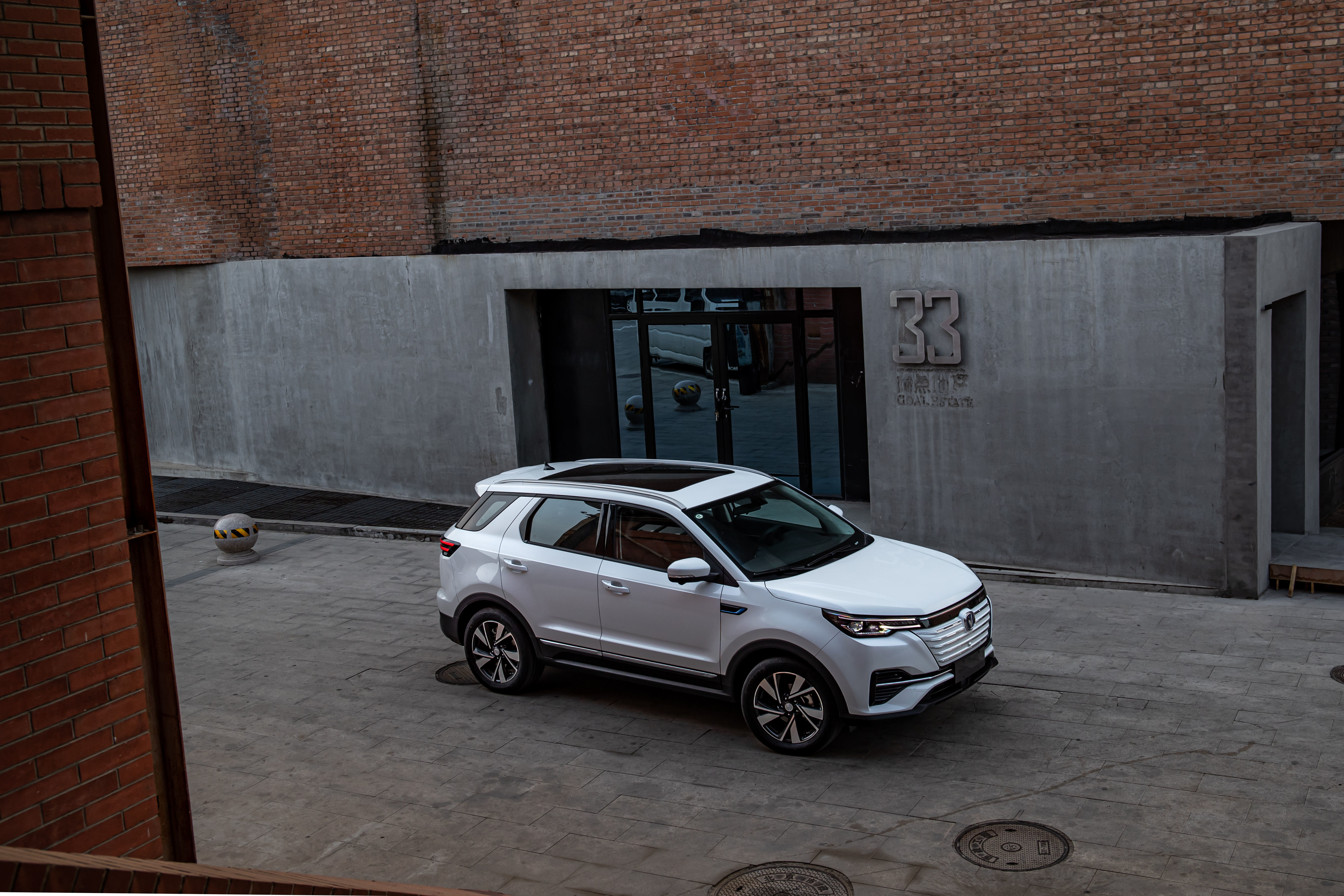White Changan CS55 E-Rock SUV parked in urban setting HD Wallpaper