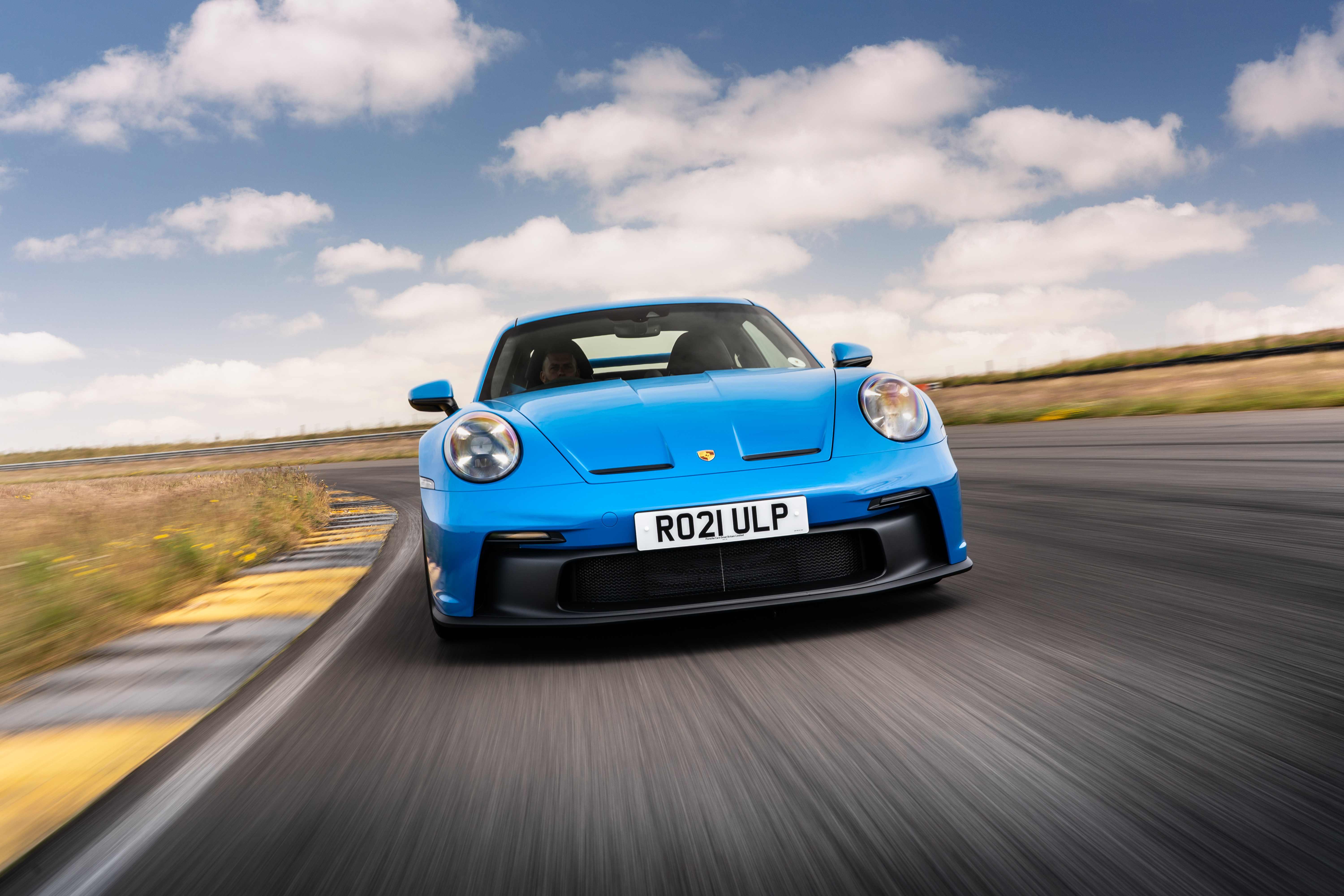 Blue 2021 Porsche 911 GT3 on a race track HD Wallpaper
