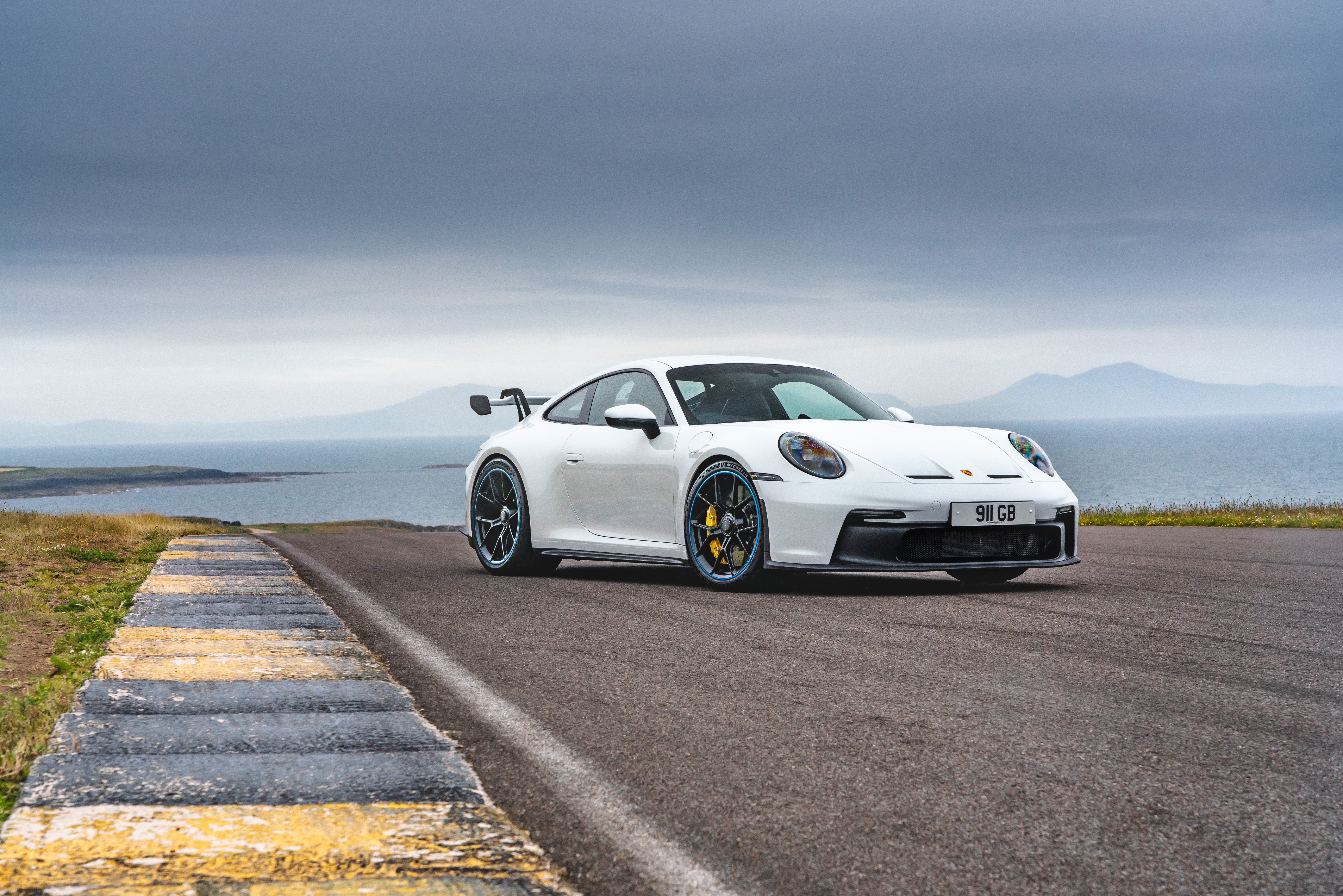 White 2021 Porsche 911 GT3 PDK on coastal road HD Wallpaper