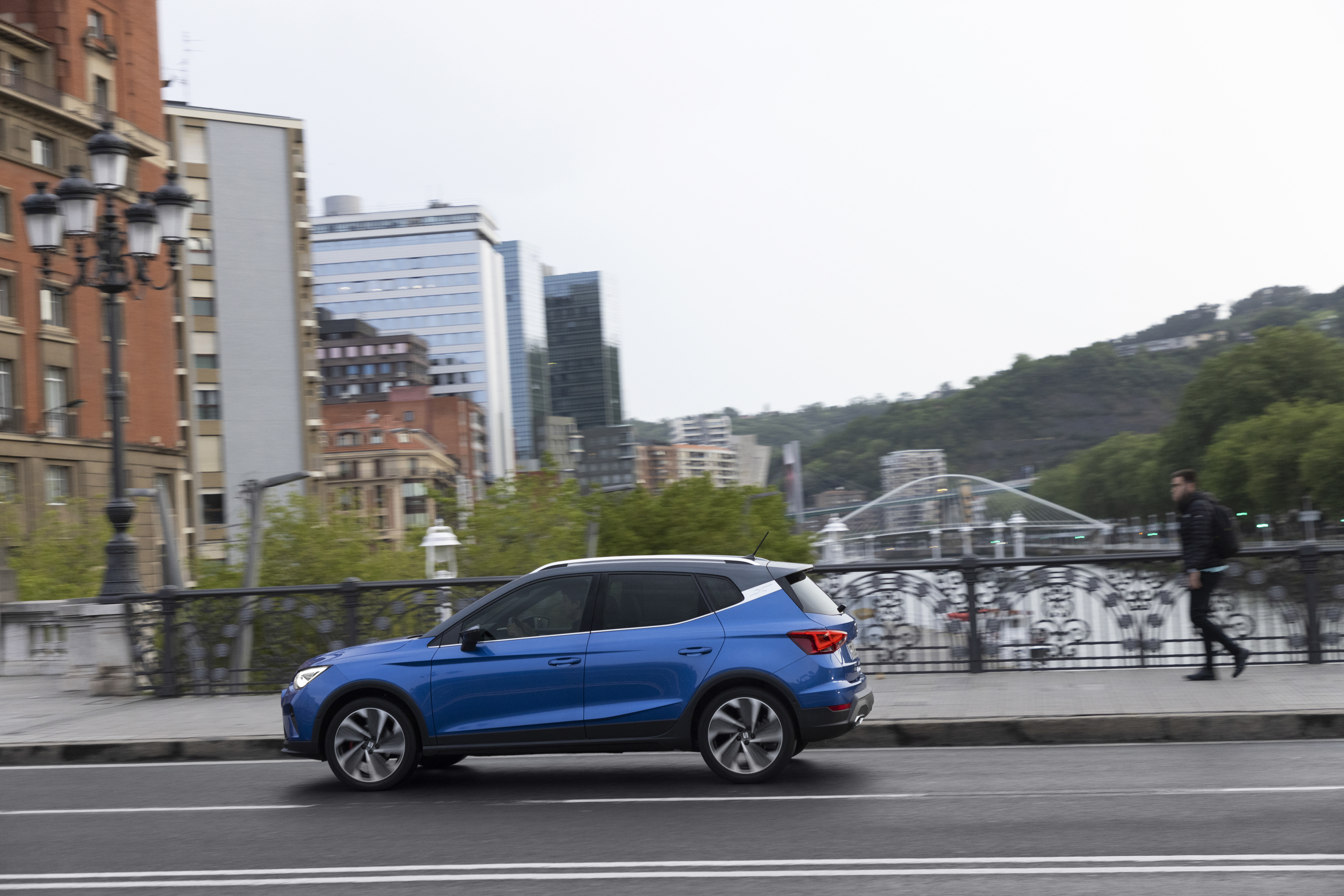 Blue 2021 SEAT Arona FR SUV driving on a bridge HD Wallpaper
