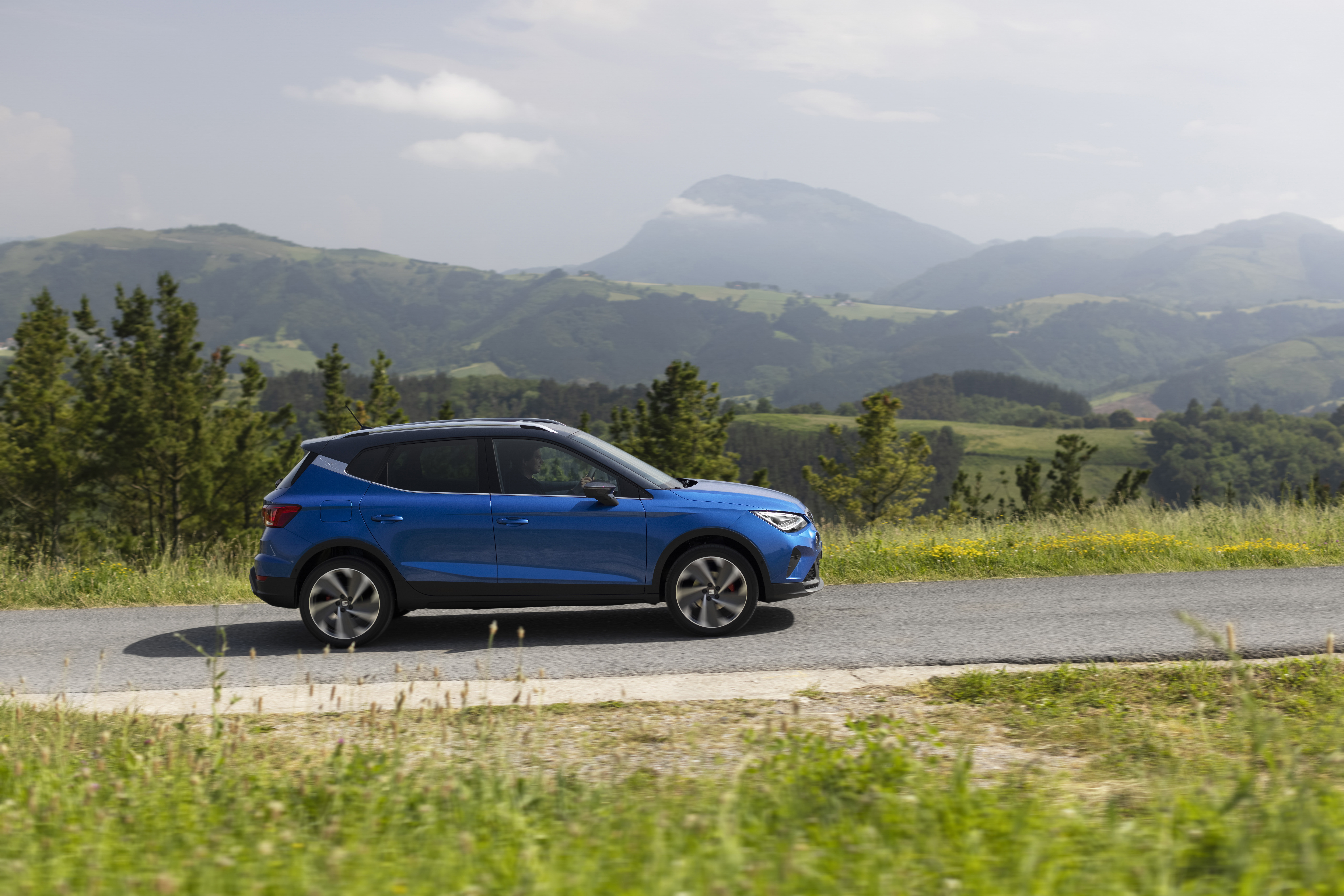 Blue 2021 SEAT Arona FR SUV driving on scenic road HD Wallpaper
